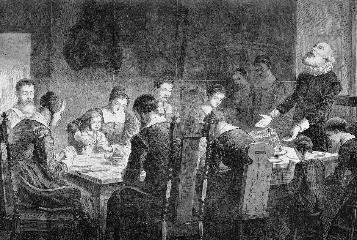 Puritans Pray At Thanksgiving Dinner