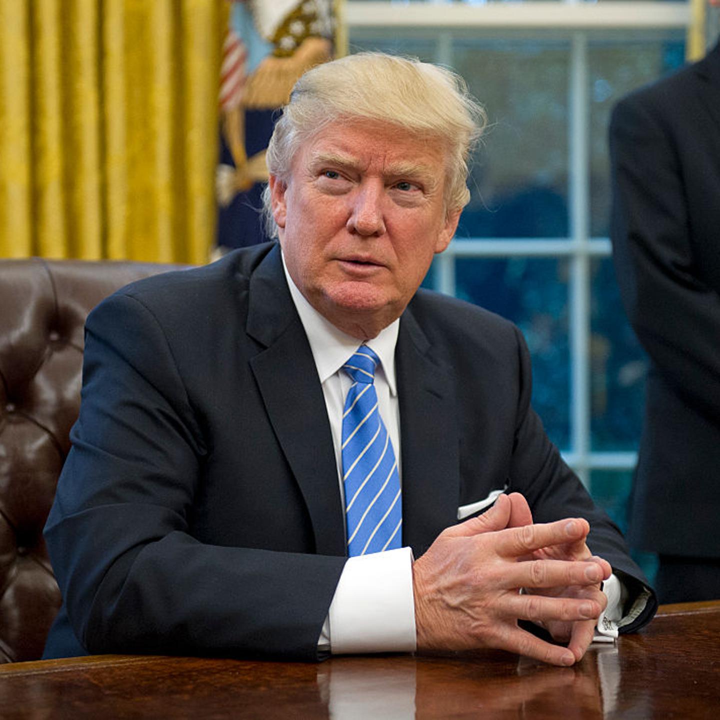 U.S. President Donald Trump prepares to sign three Executive Orders in the Oval Office of the White House in Washington, DC on Monday, January 23, 2017.