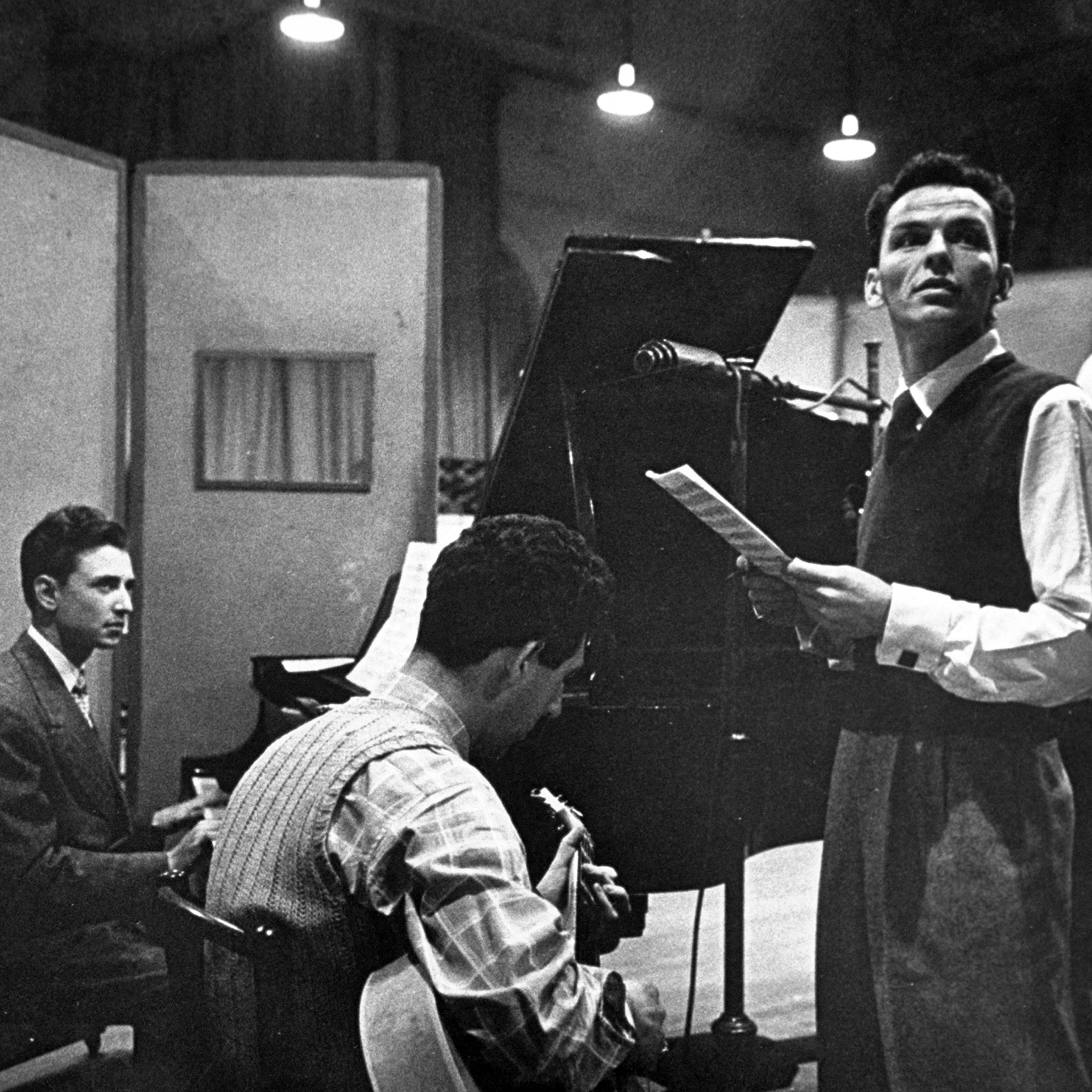 Frank Sinatra and musicians in studio during recording session at CBS.