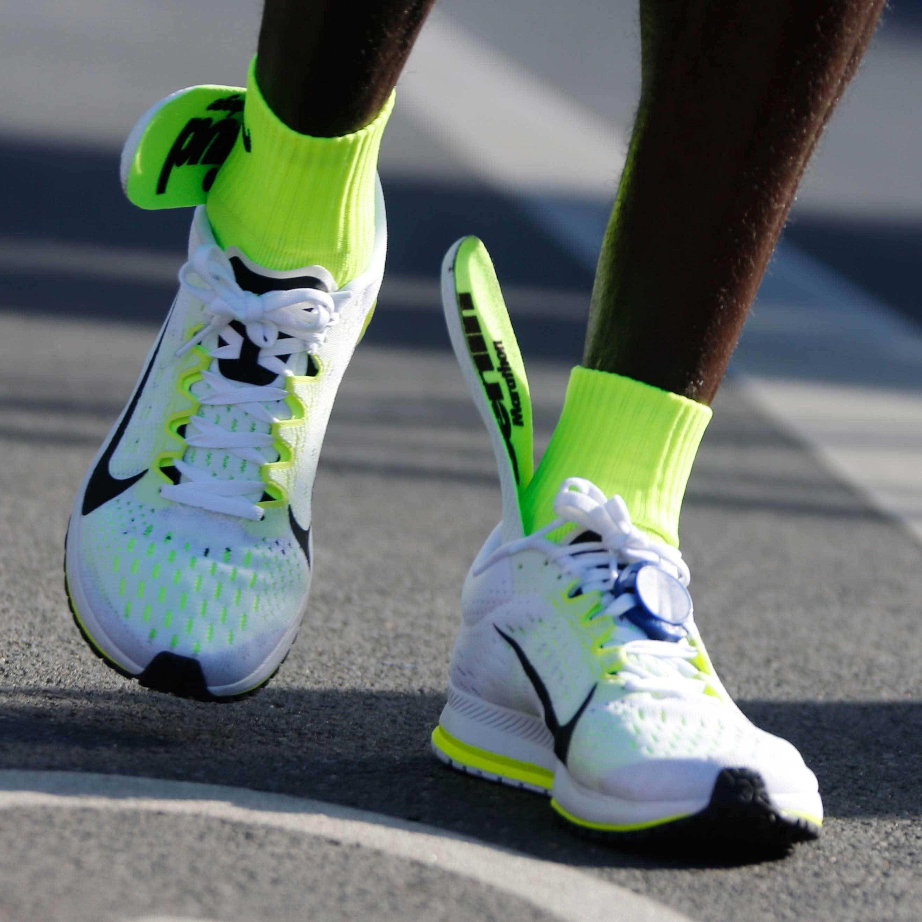 The insoles of Kenya's Kipchoge's running shoes are seen slipping up to his ankles after he crosses finish line to win the men's 42nd Berlin marathon