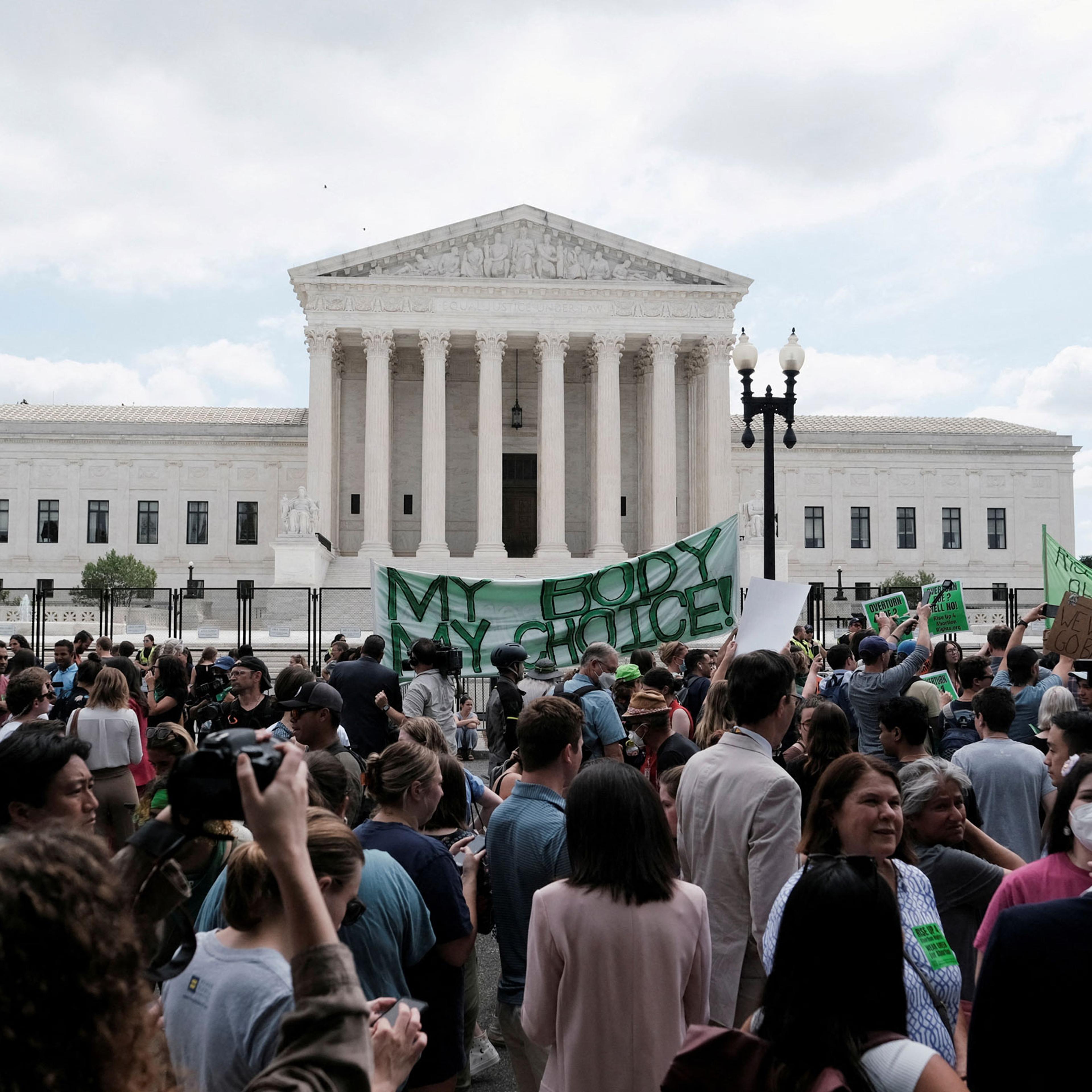 Demonstrators gather outside the United States Supreme Court as the court rules in the Dobbs v Women's Health Organization abortion case