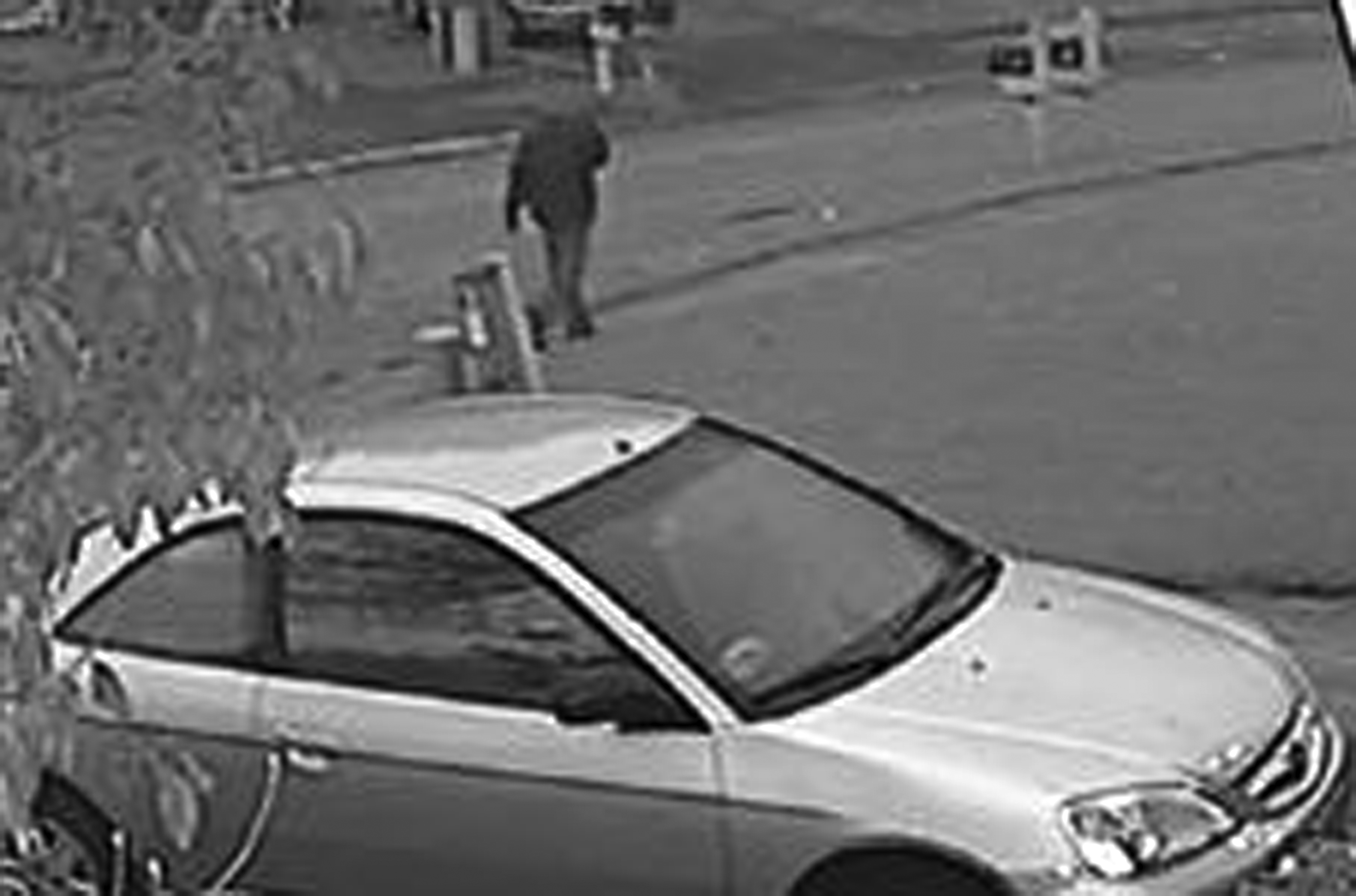 This frame grab from surveillance video provided by the Indianapolis Metropolitan Police Department shows a possible suspect walking in the neighborhood where an Indianapolis pastor's wife was shot on Nov. 10, 2015.