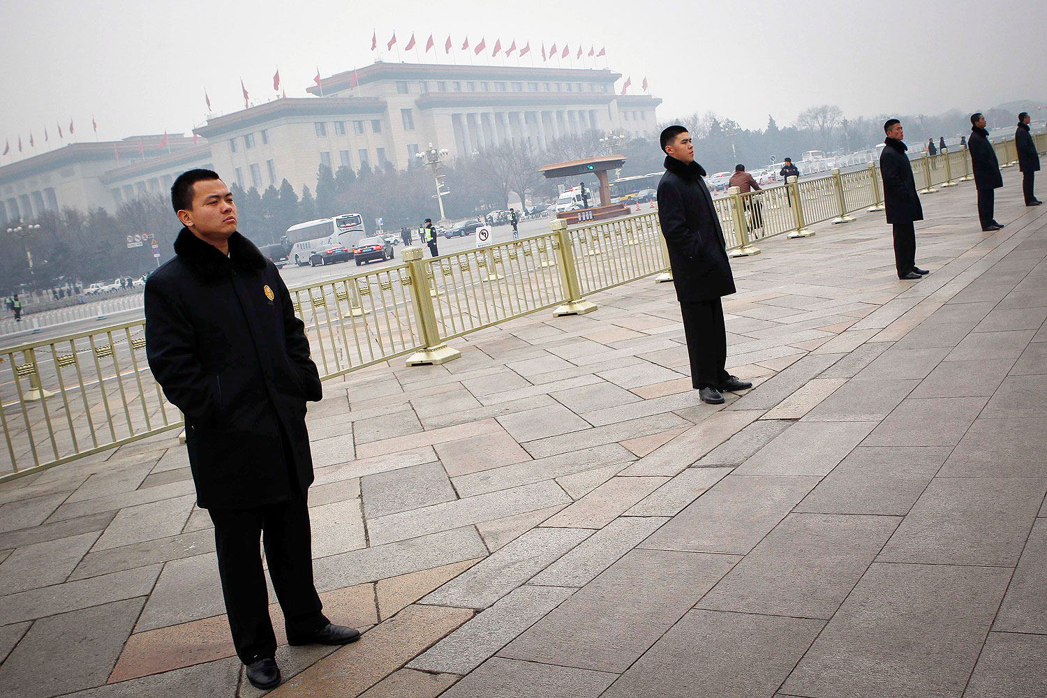Chinese security guards stand in line in Tiananmen Square in Beijing, on March 3, 2014. Beijing has stepped up security for the NPC and CPPCC sessions this week