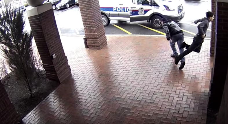 Screenshot from Columbus Division of Police footage showing the moment 'Bill' tripped the 18-year-old suspect on April 3, 2018.

