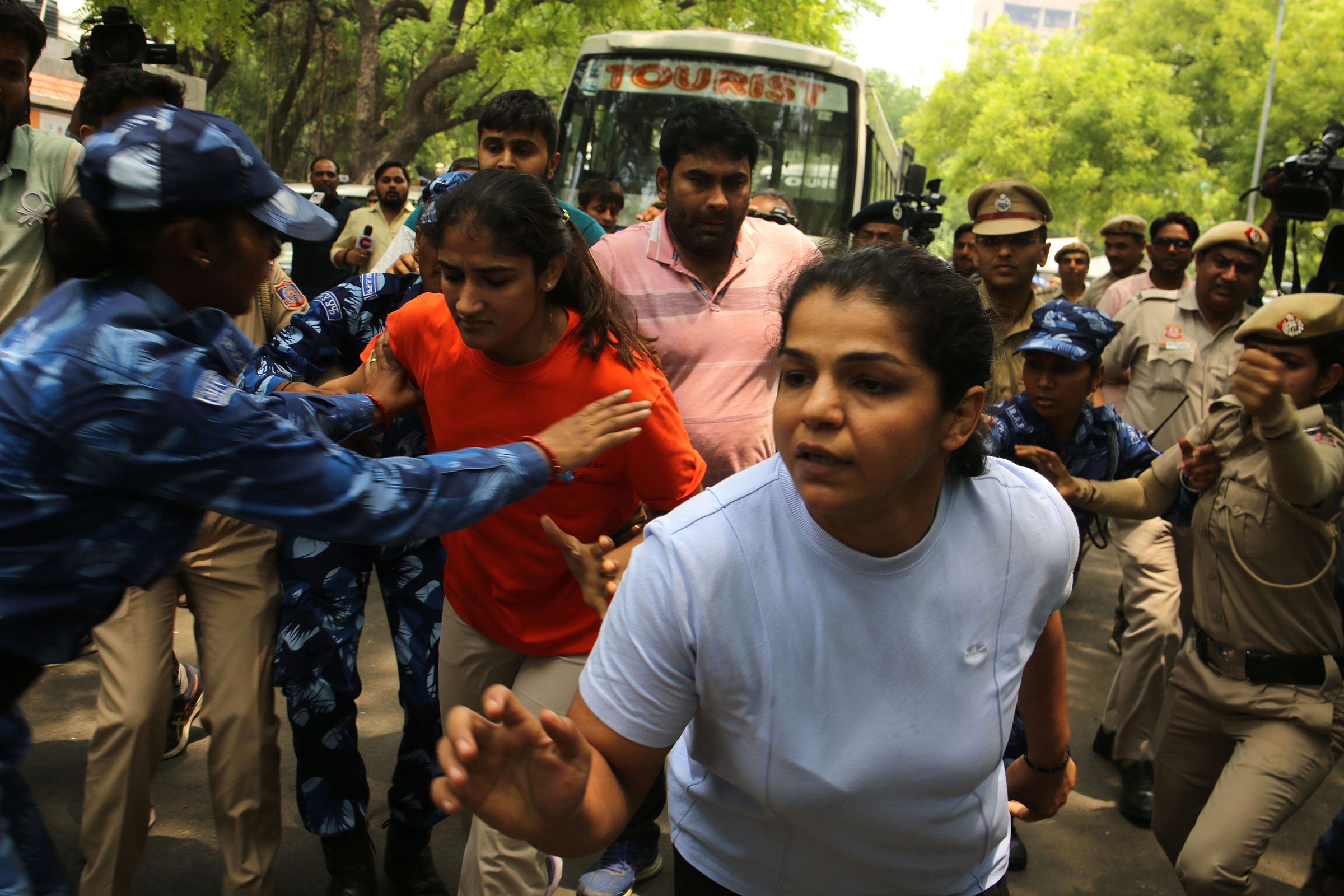 Wrestlers Sakshi Malik, Vinesh Phogat, and Bajrang Punia, along with supporters march toward India's parliament on May 28. 