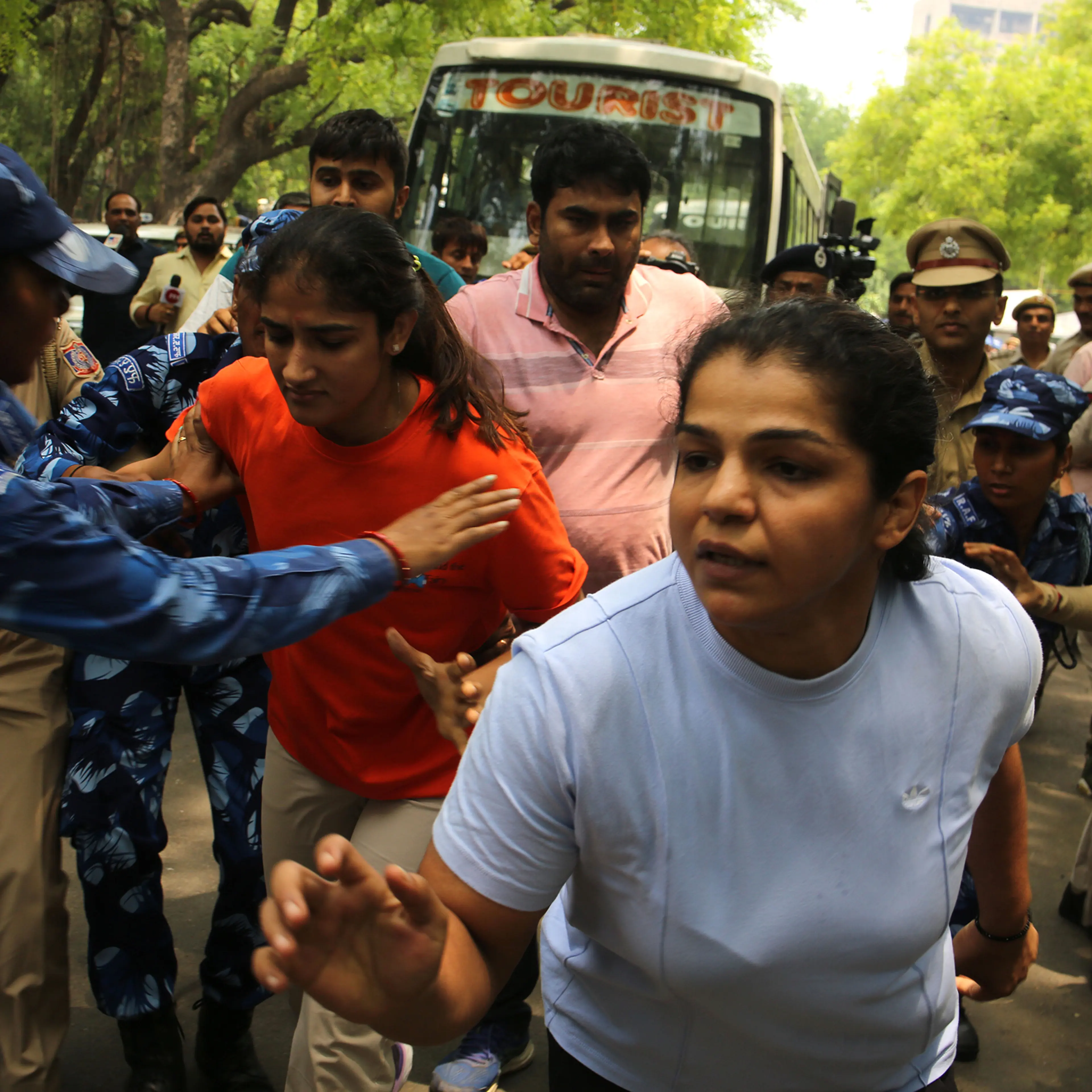 Wrestlers Sakshi Malik, Vinesh Phogat, and Bajrang Punia, along with supporters march toward India's parliament on May 28.