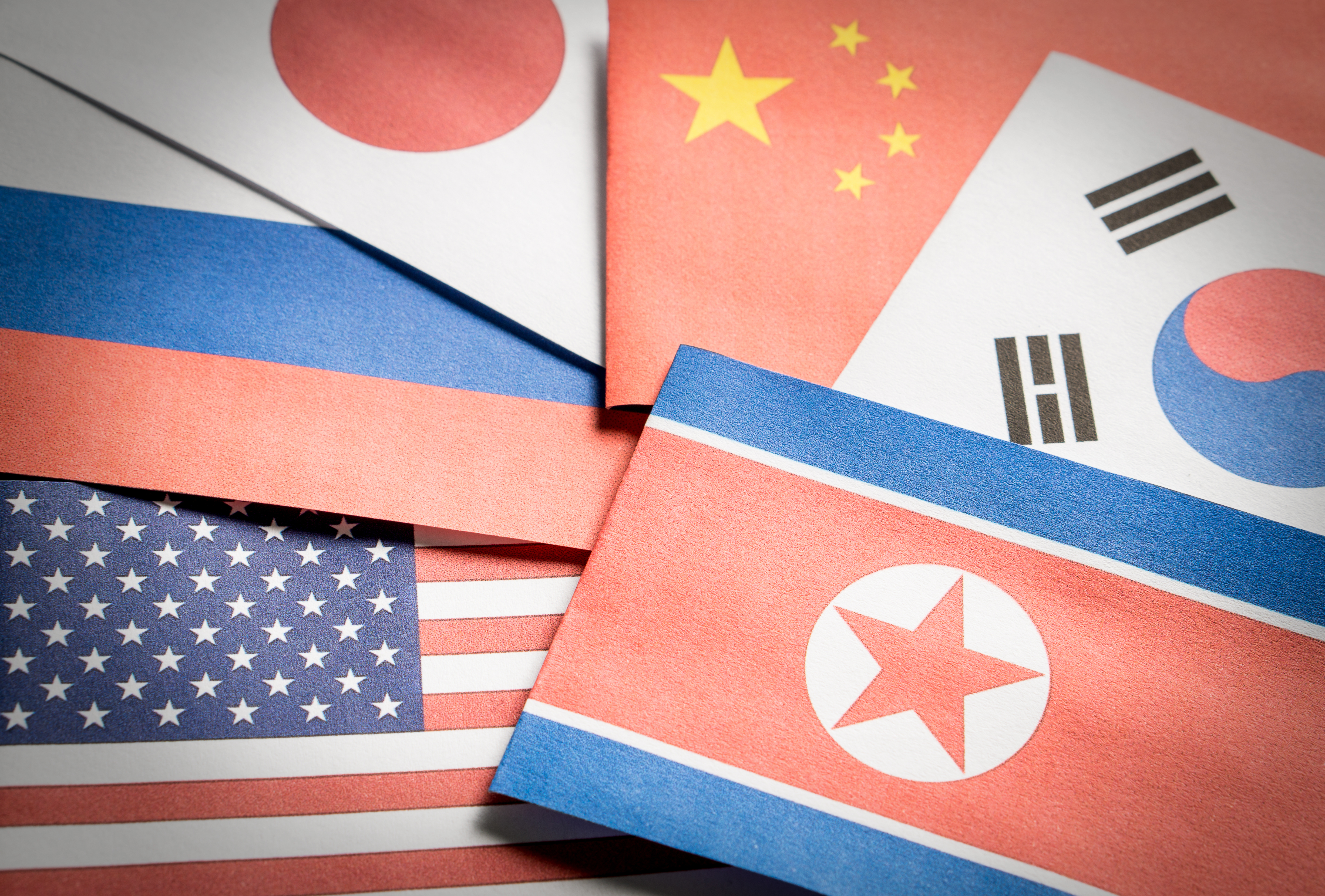 The flag of North Korea, South Korea, United Stated of America (USA), Russia, Japan and China made from paper.
