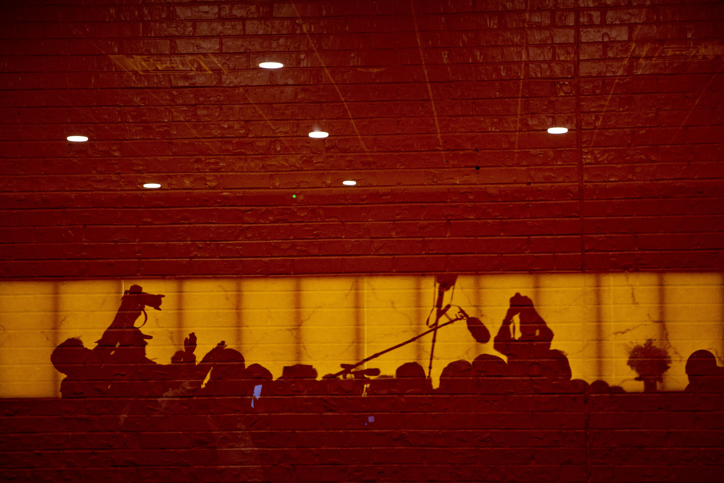 Members of the media are reflected in a window during an organizing event for Senator Elizabeth Warren in Council Bluffs, Iowa, on Jan. 4, 2019.