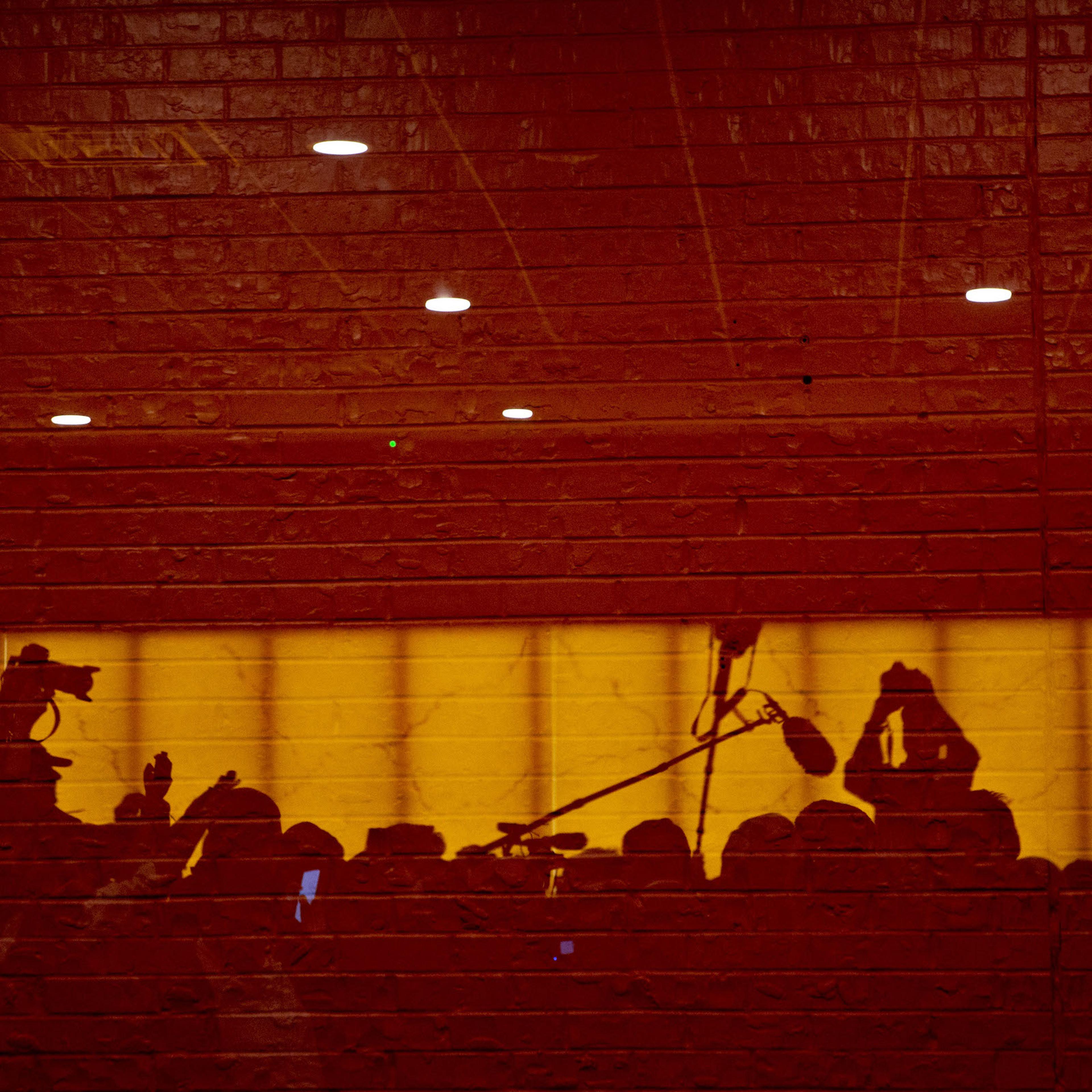 Members of the media are reflected in a window during an organizing event for Senator Elizabeth Warren in Council Bluffs, Iowa, on Jan. 4, 2019.