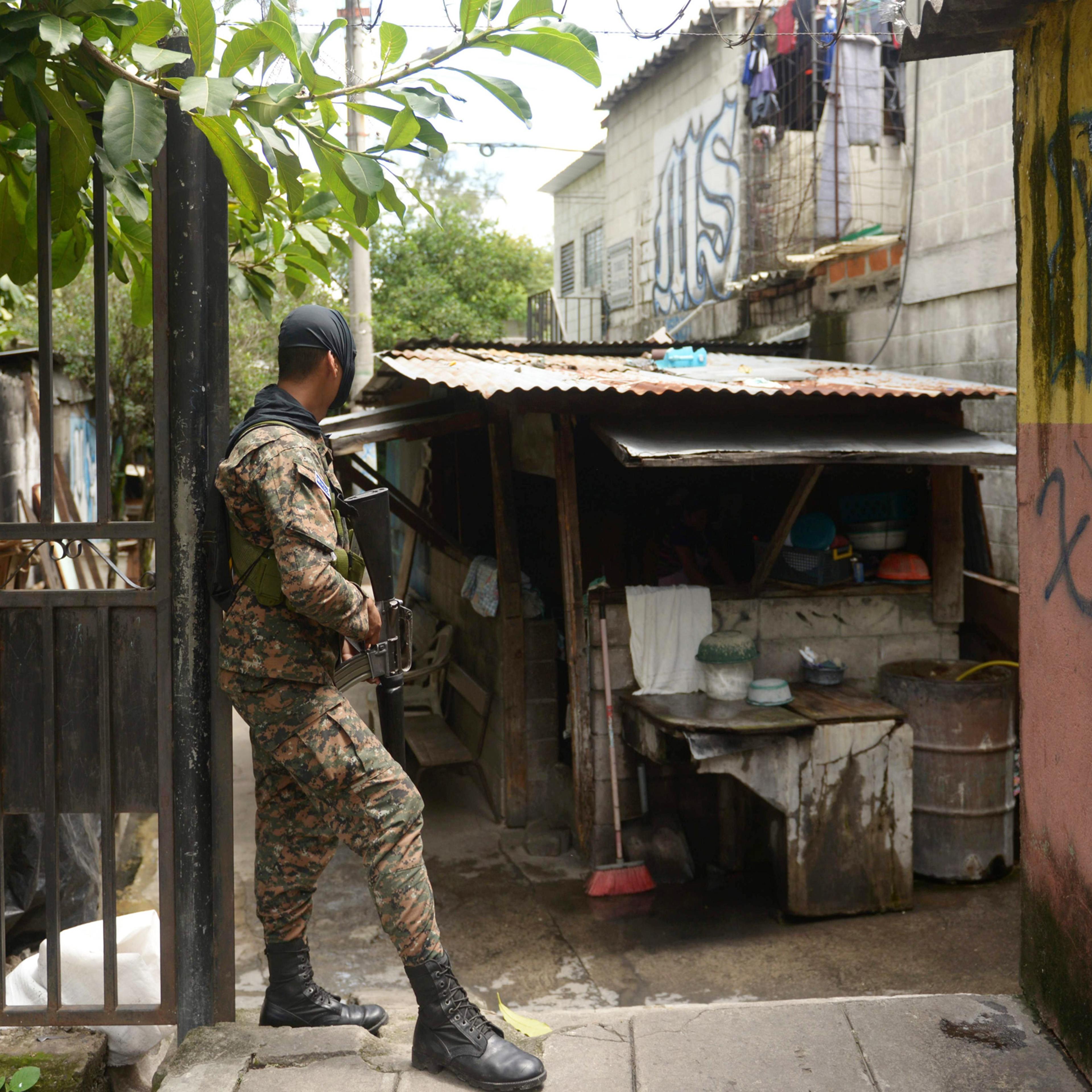 A soldier stands guard in a neighborhood dominated by the Mara Salvatrucha's gang in San Salvador, during an operation to take back gang-controlled neighborhoods, on Aug. 16, 2016.