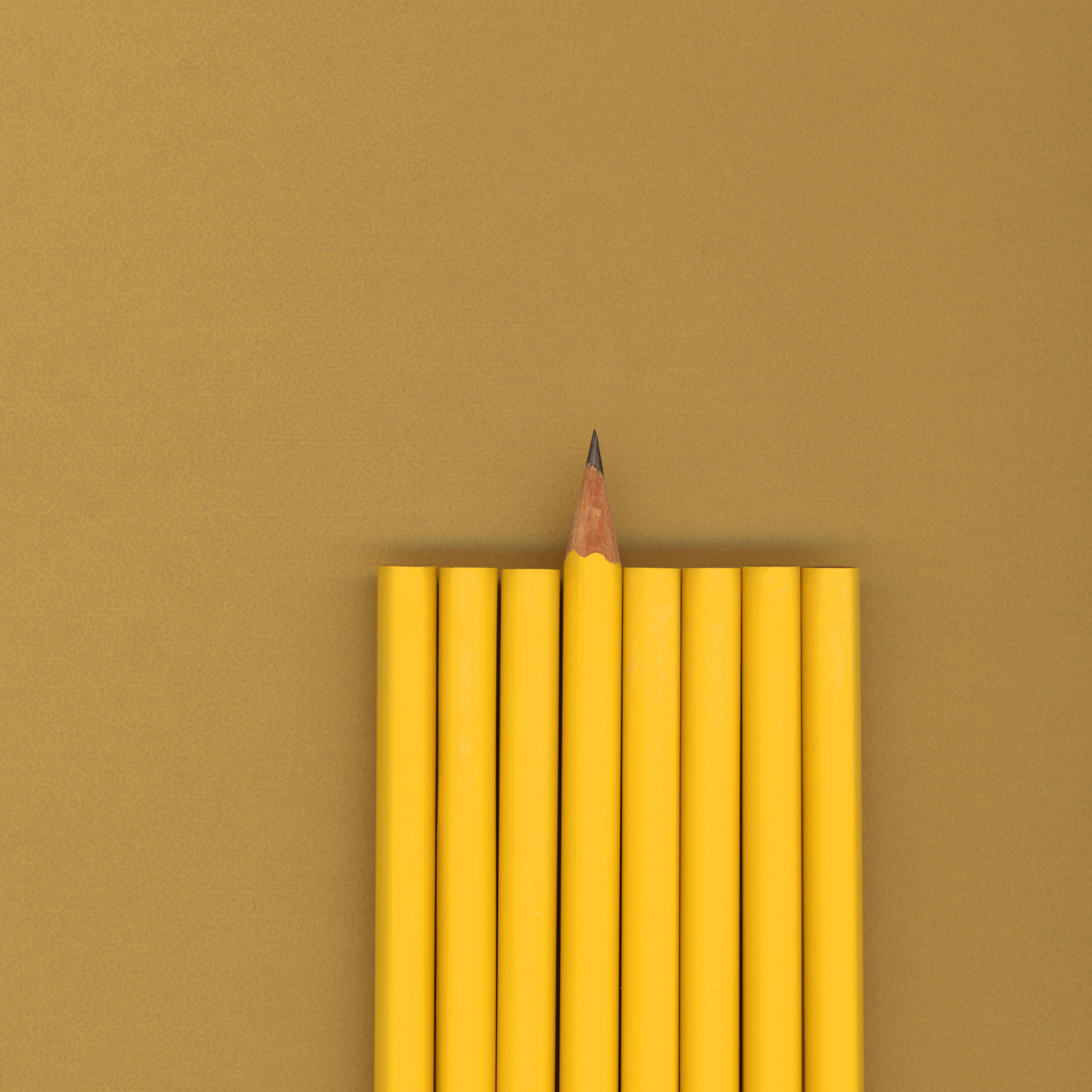 Sharpened pencil next to unsharpened pencils