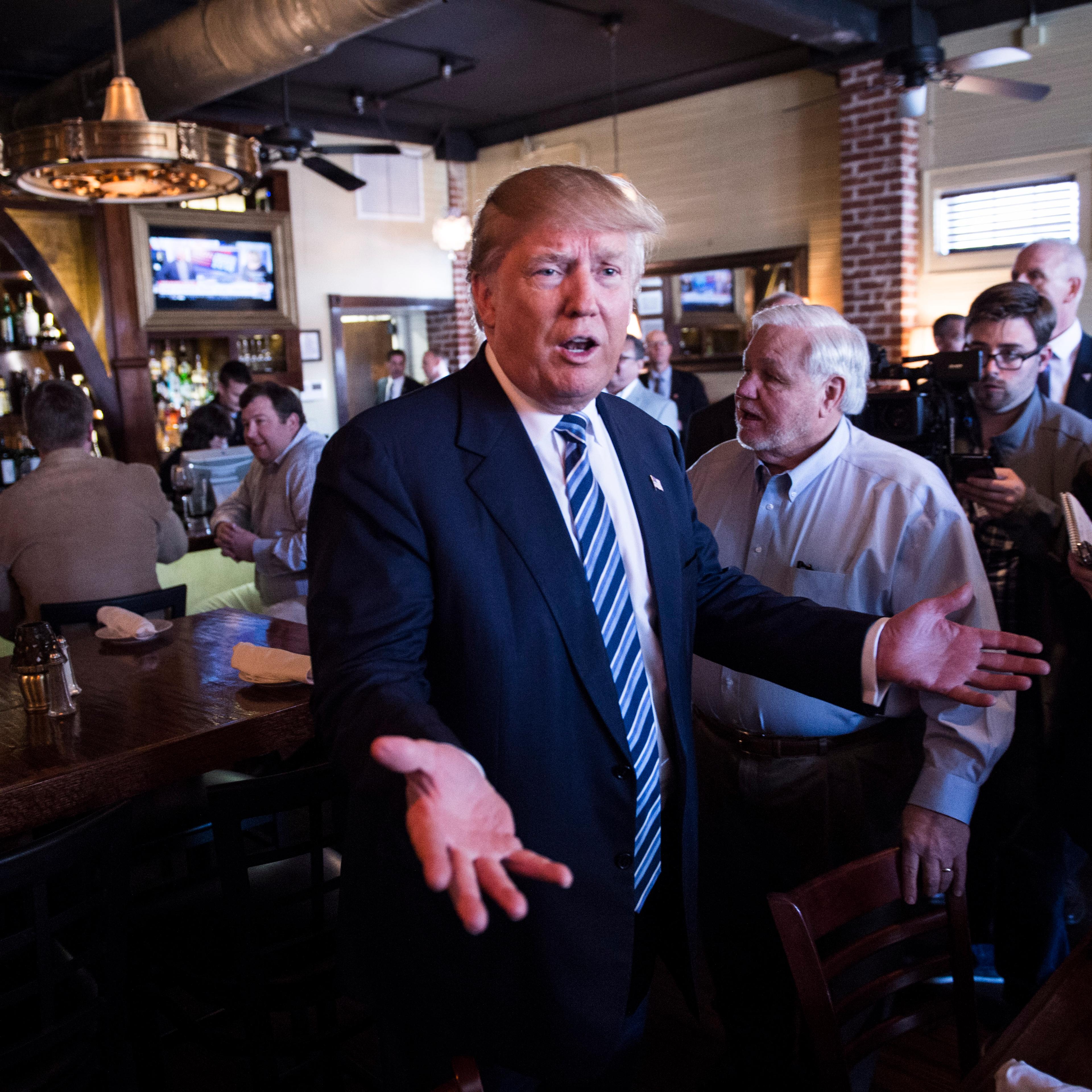 Republican presidential candidate Donald Trump greets people while making a stop for lunch between campaign events at Fratello's Italian Tavern in North Charleston, S.C. on Feb. 18, 2016.