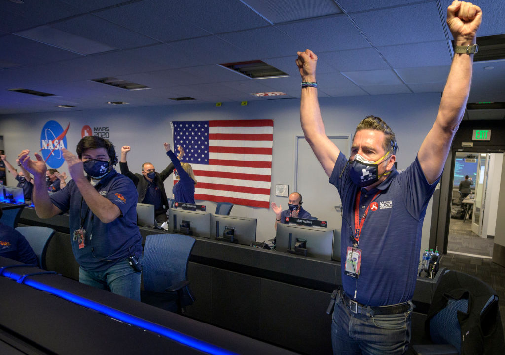 Members of NASA's Perseverance rover team react in mission control after receiving confirmation the spacecraft successfully touched down on Mars, , February 18, 2021 at NASA's Jet Propulsion Laboratory in Pasadena, California.