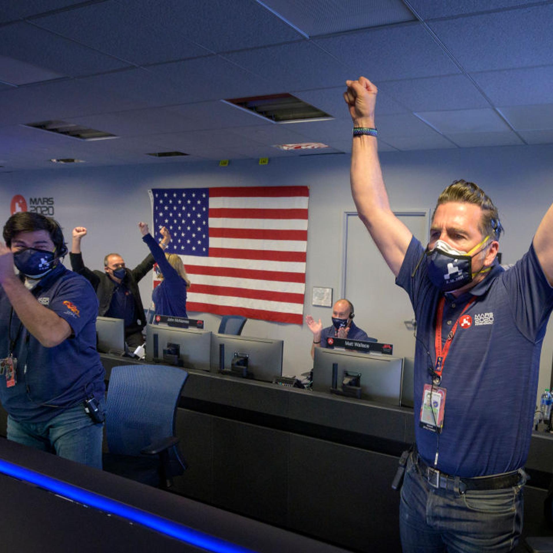 Members of NASA's Perseverance rover team react in mission control after receiving confirmation the spacecraft successfully touched down on Mars, , February 18, 2021 at NASA's Jet Propulsion Laboratory in Pasadena, California.