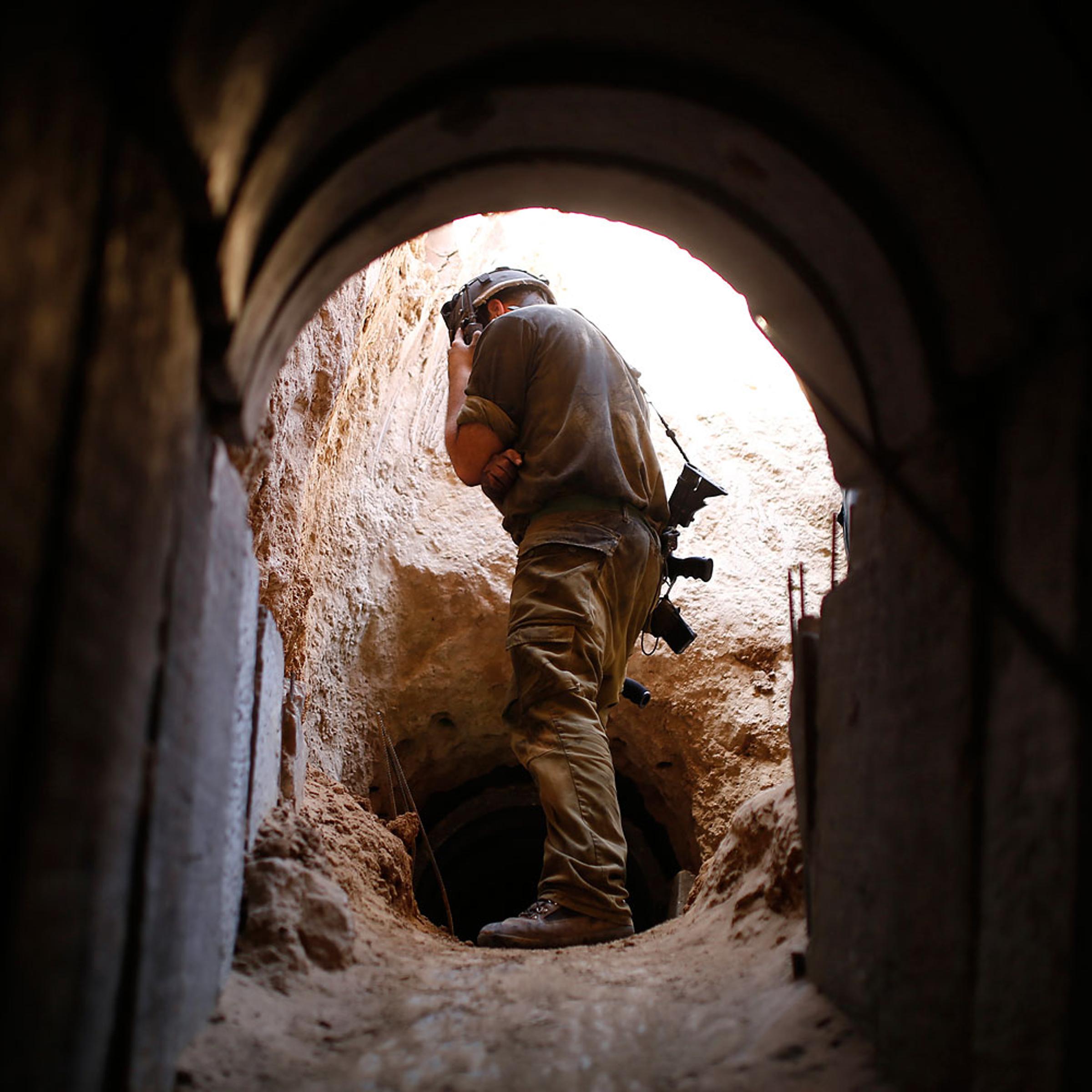 An Israeli soldier looks at a tunnel exposed by the Israeli military near Kibbutz Ein Hashlosha, just outside the southern Gaza Strip, Oct.13, 2013.