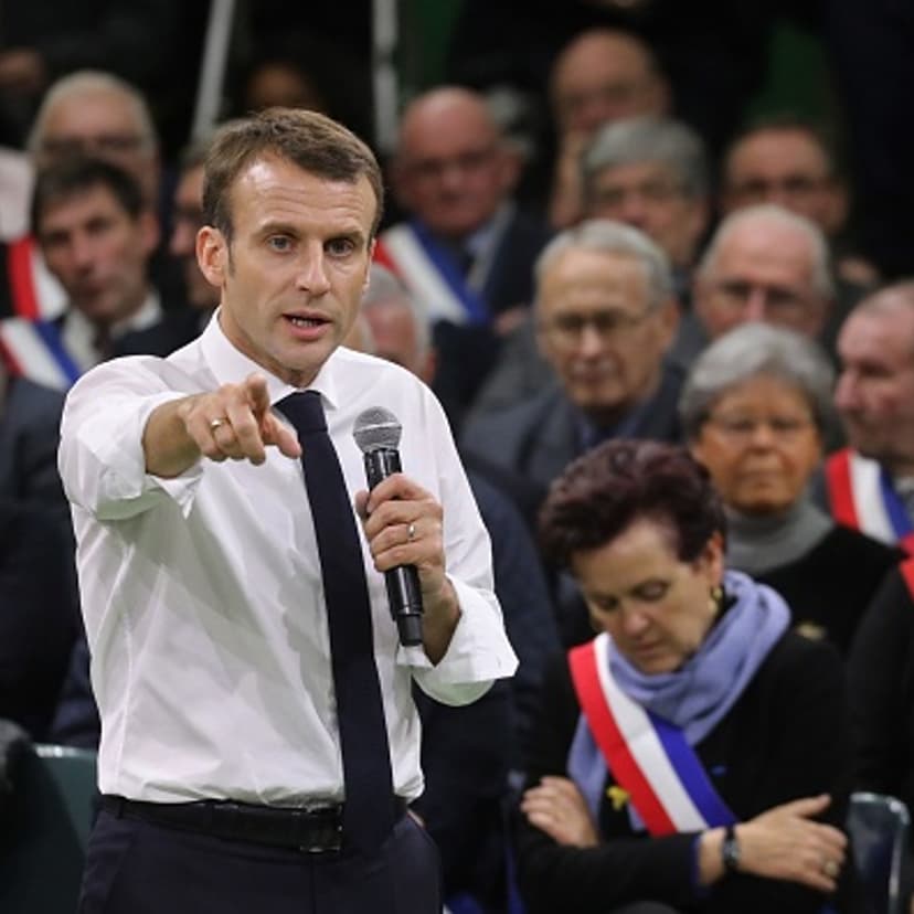 French President Emmanuel Macron (L) gestures as he speaks during meeting gathering some 600 mayors who will relay the concerns aired by residents in their towns and villages in the Normandy city of Grand Bourgtheroulde on January 15, 2019, as part of th