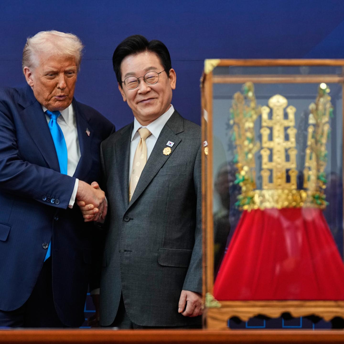 President Donald Trump shakes hands with South Korean President Lee Jae Myung as he receives a gift of a gold crown and an award of the Grand Order of Mugunghwa, not seen, during a high honor ceremony at the Gyeongju National Museum in Gyeongju, South Ko