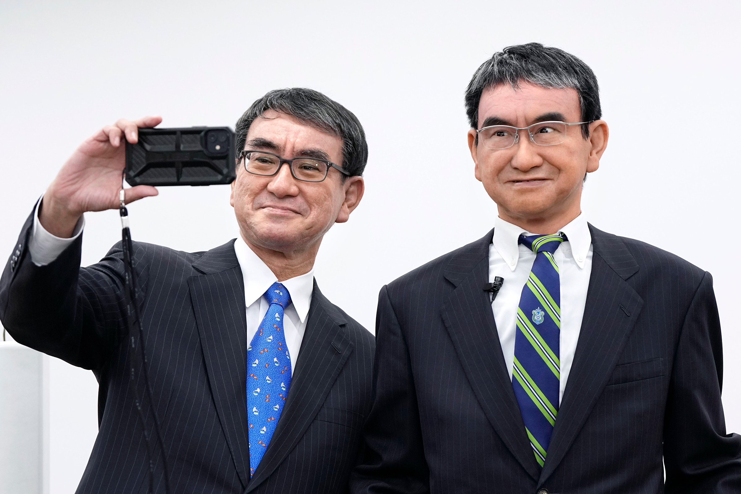 Japanese Digital Minister Taro Kono takes a selfie with his avatar robot in Tokyo on Oct. 21, 2022.
