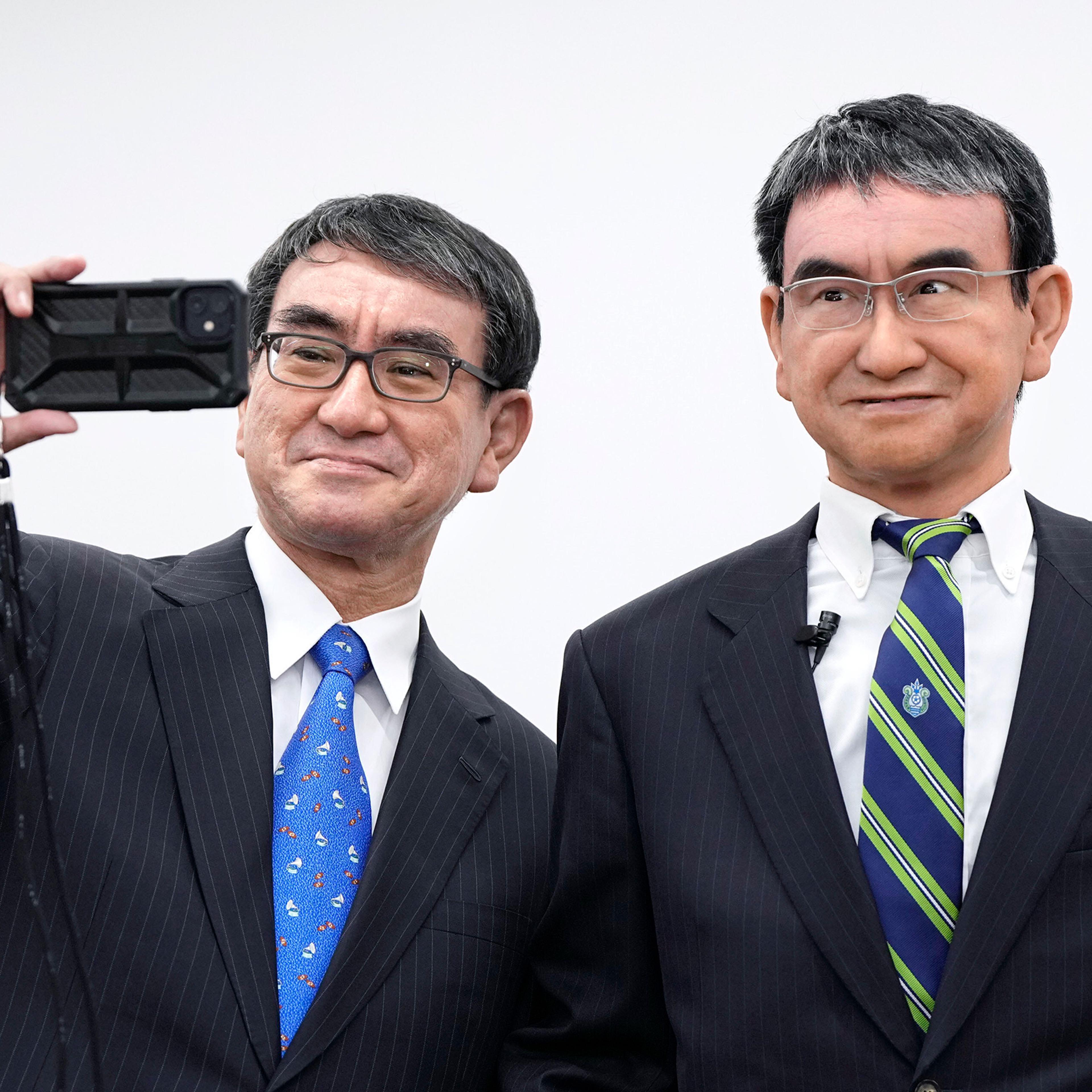 Japanese Digital Minister Taro Kono takes a selfie with his avatar robot in Tokyo on Oct. 21, 2022.