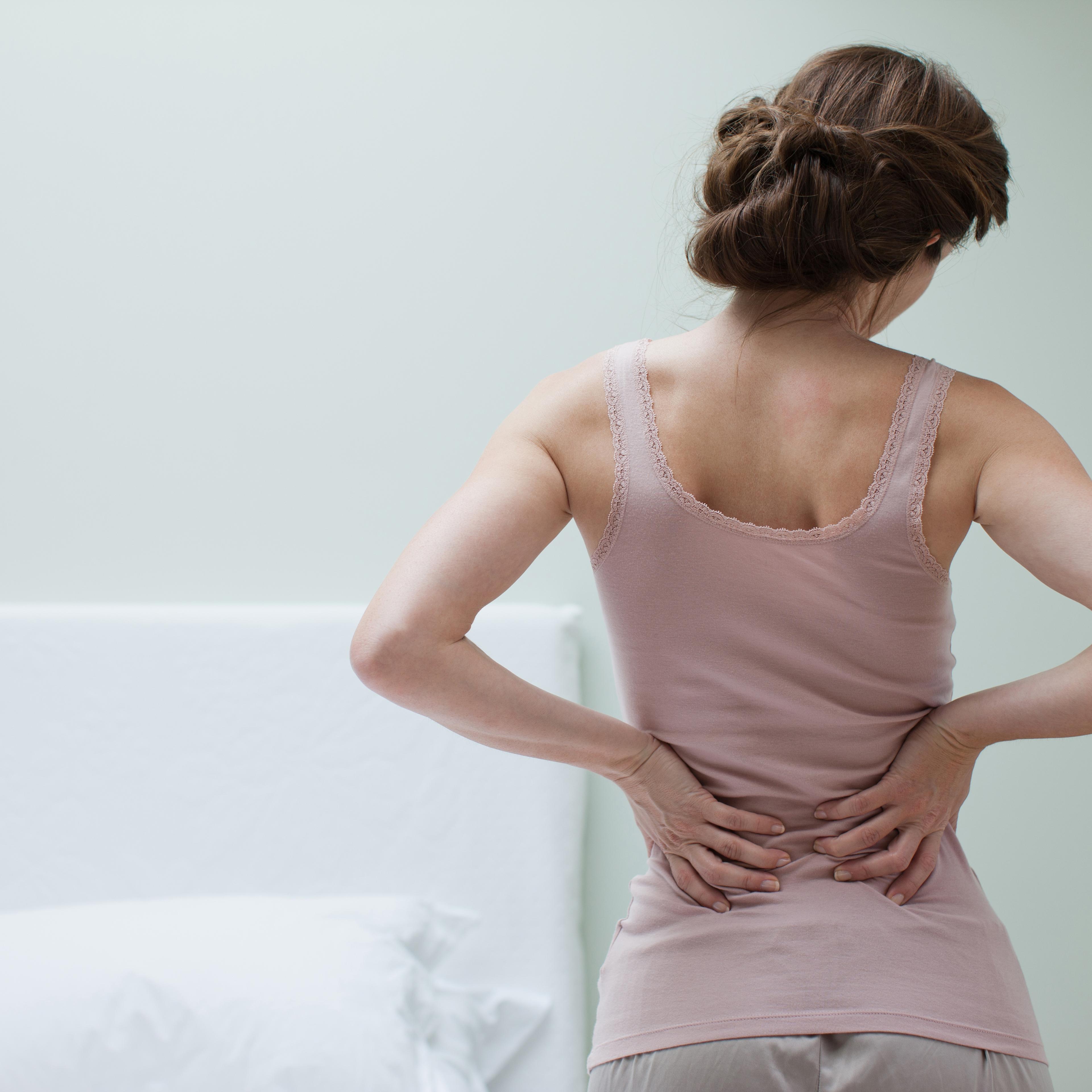 Woman rubbing aching back