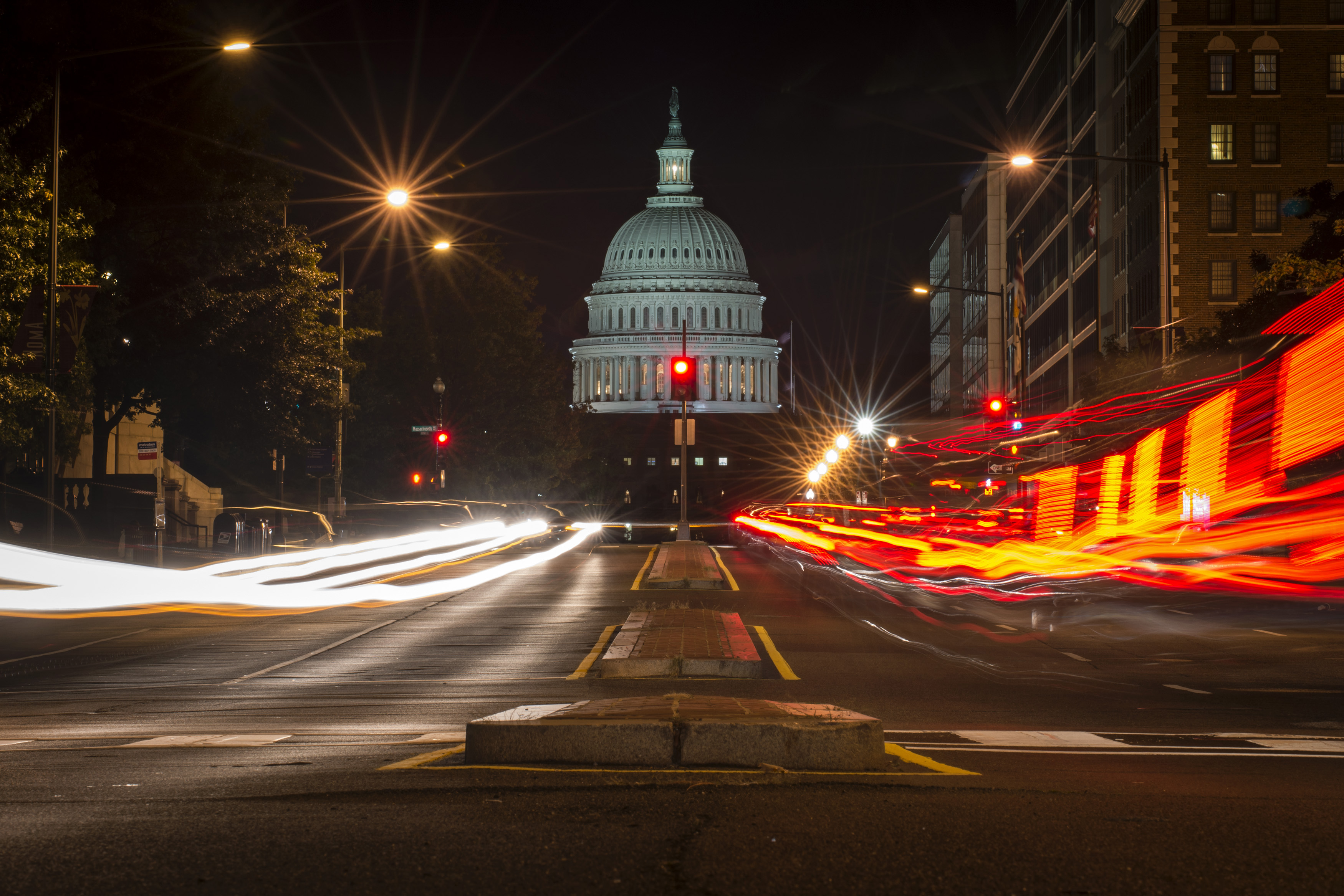 A red traffic light stands in front of the U.S. Capitol building in Washington