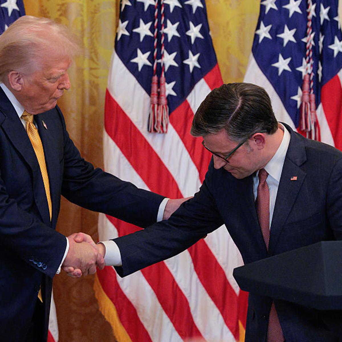 U.S. President Donald Trump and House Speaker Mike Johnson shake hands at a reception for Republican members of the House of Representatives in the East Room of the White House on July 22, 2025 in Washington, DC. Trump thanked GOP lawmakers for passing t