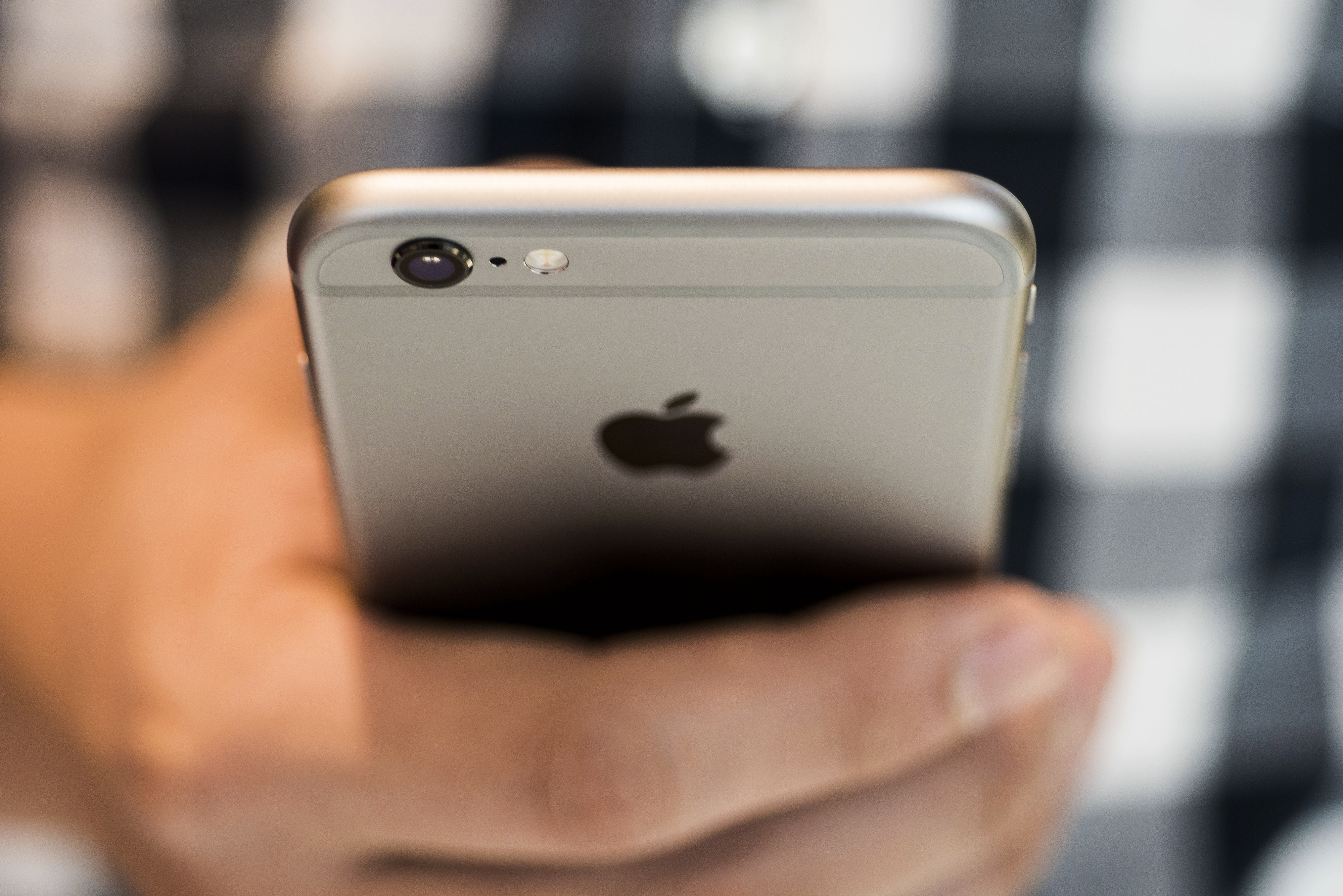 An Apple Inc. iPhone 6S smartphone is held for an arranged photograph in Hong Kong, China, on Friday, Sept. 25, 2015.