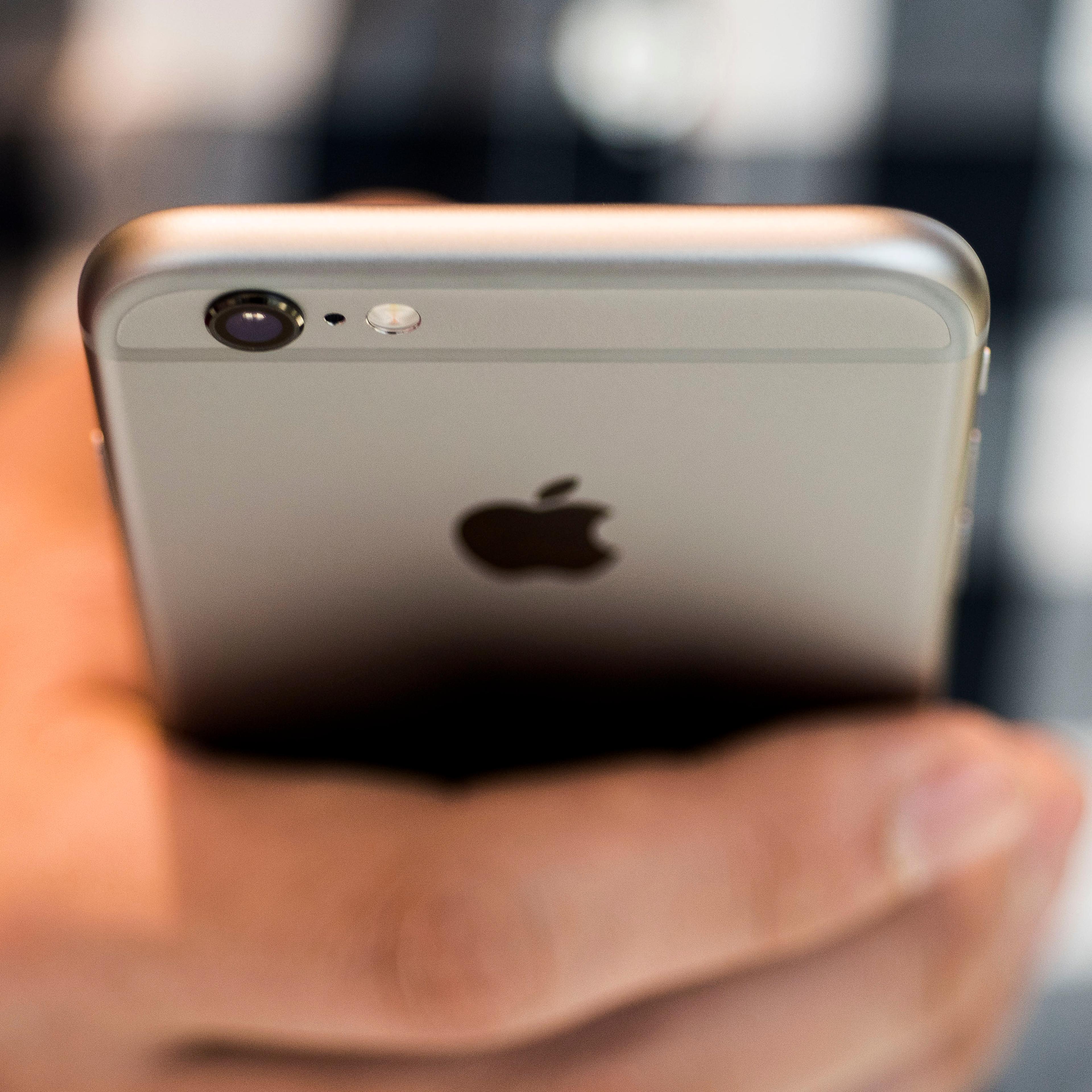 An Apple Inc. iPhone 6S smartphone is held for an arranged photograph in Hong Kong, China, on Friday, Sept. 25, 2015.