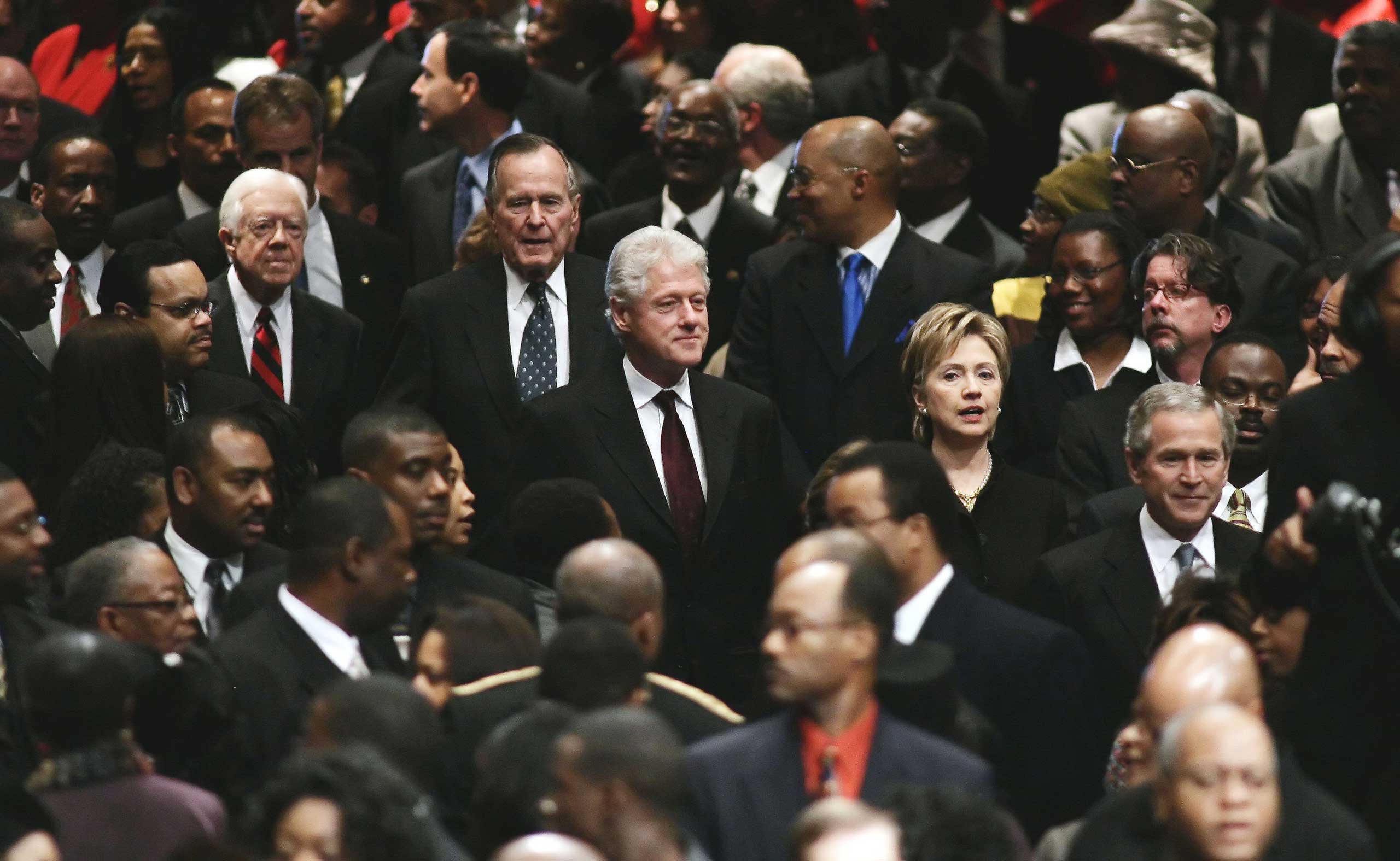 President George Bush, U.S. Sen. Hillary Clinton (D-NY), former U.S. President Bill Clinton, former U.S. President George H. W. Bush, and former U.S. President Jimmy Carter walk through the crowd during the funeral for Coretta Scott King at the New Birth
