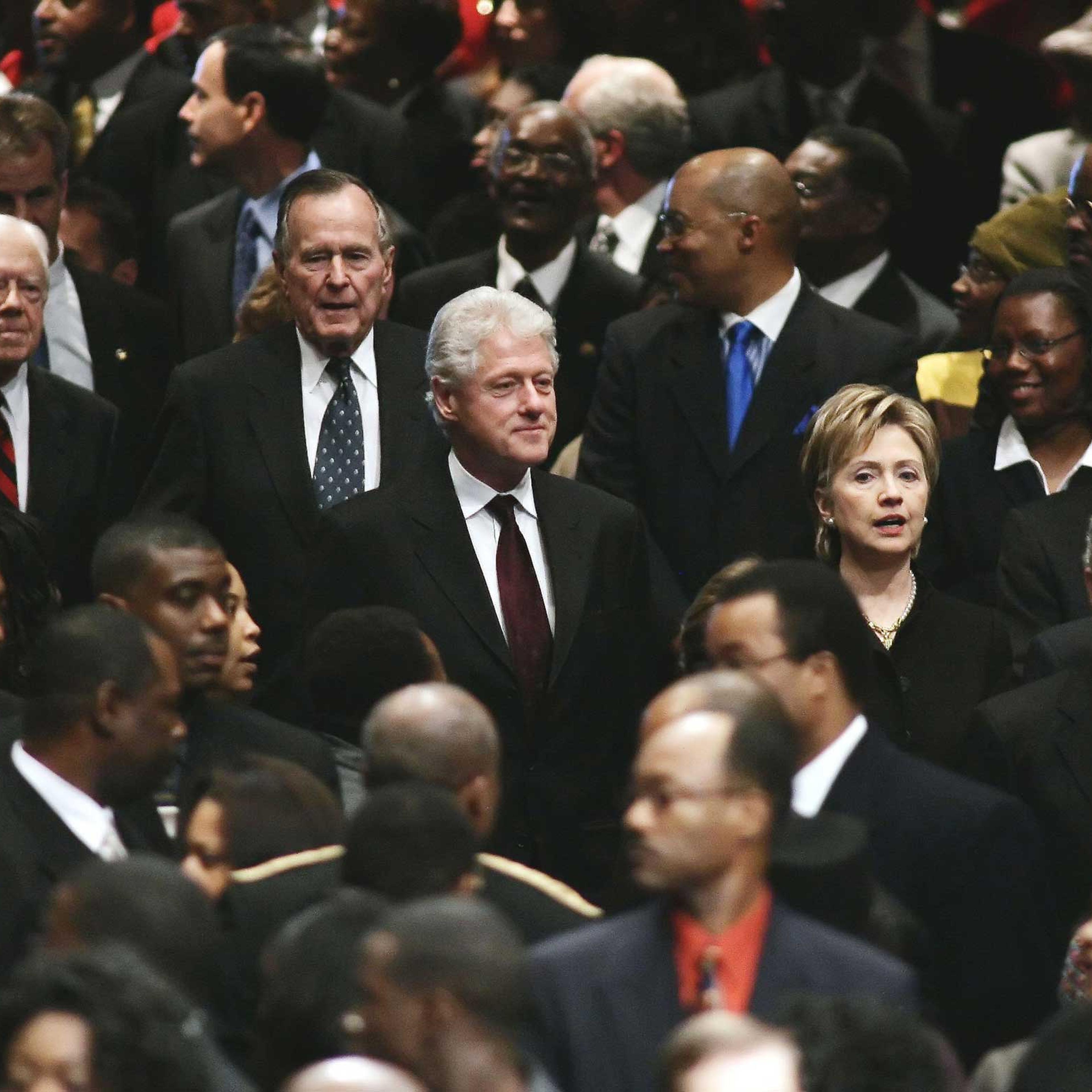 President George Bush, U.S. Sen. Hillary Clinton (D-NY), former U.S. President Bill Clinton, former U.S. President George H. W. Bush, and former U.S. President Jimmy Carter walk through the crowd during the funeral for Coretta Scott King at the New Birth