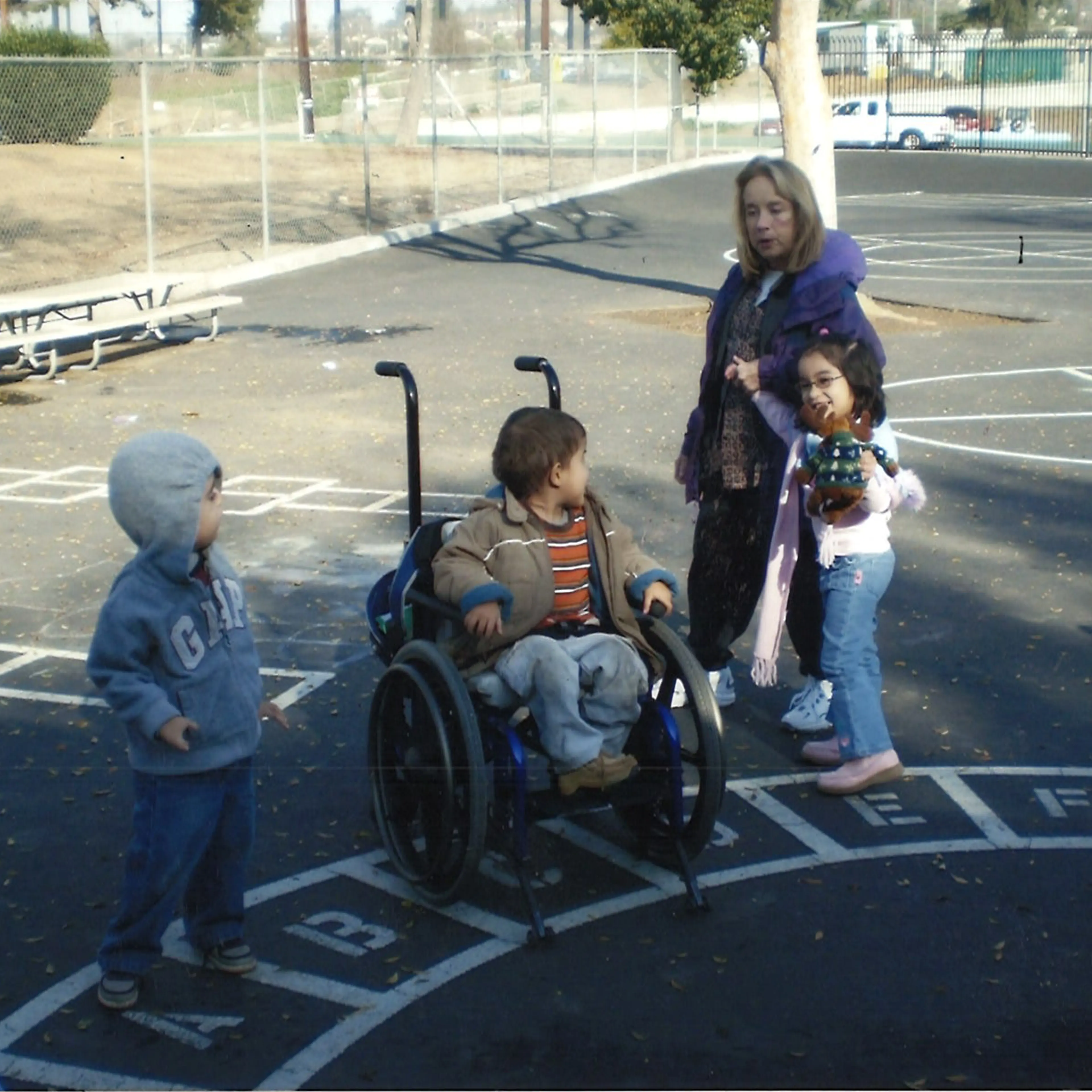The author, right, in 2007, walks with her occupational therapist alongside other students in her special education class. Due to her IEP, her occupational therapist accompanied her each day on the playground and to lunch to ensure that she did not fall