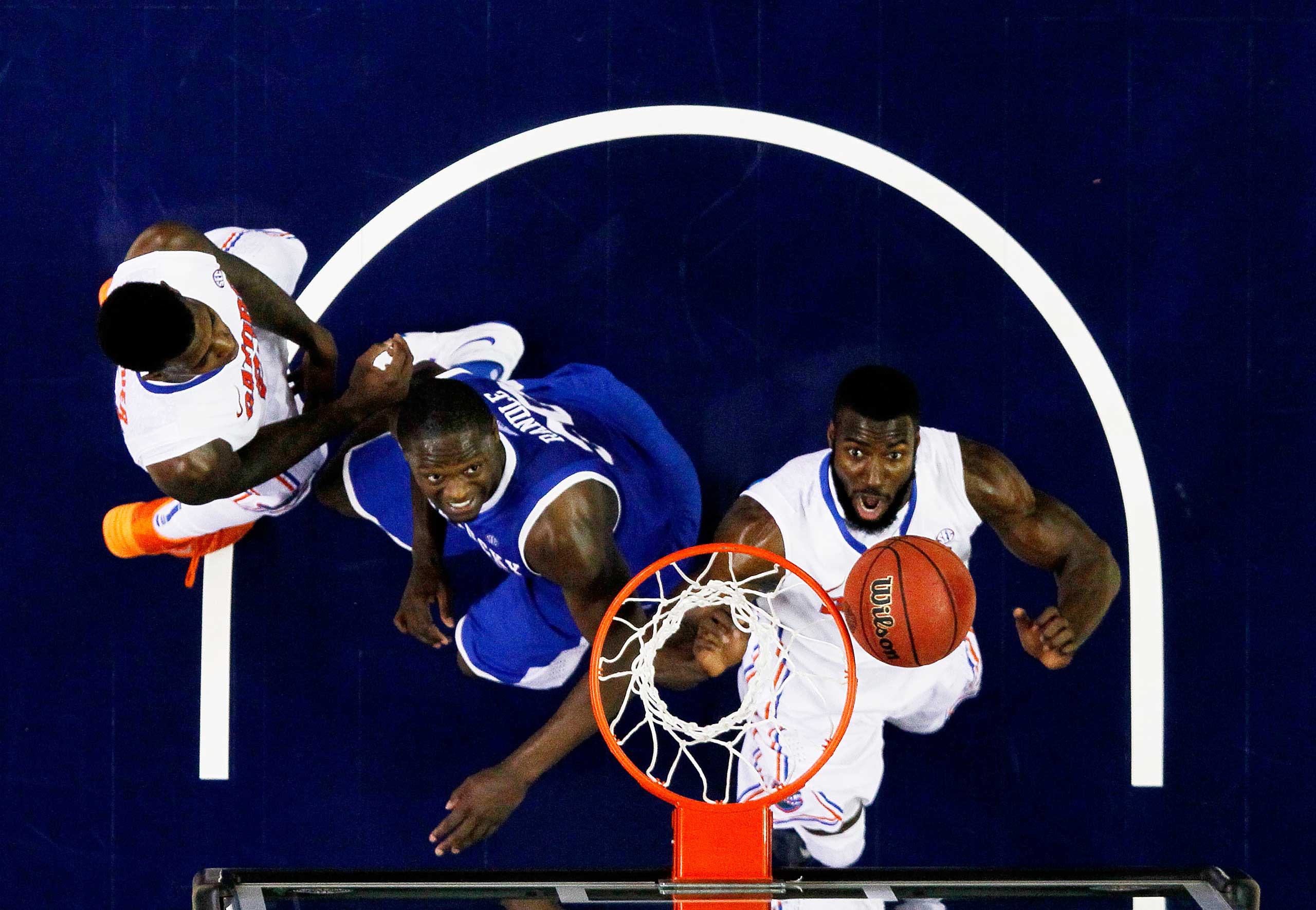 Patric Young #4 of the Florida Gators and Julius Randle #30 of the Kentucky Wildcats vie for a rebound in the second half during the Championship game of the 2014 Men's SEC Basketball Tournament at Georgia Dome on March 16, 2014 in Atlanta, Georgia.