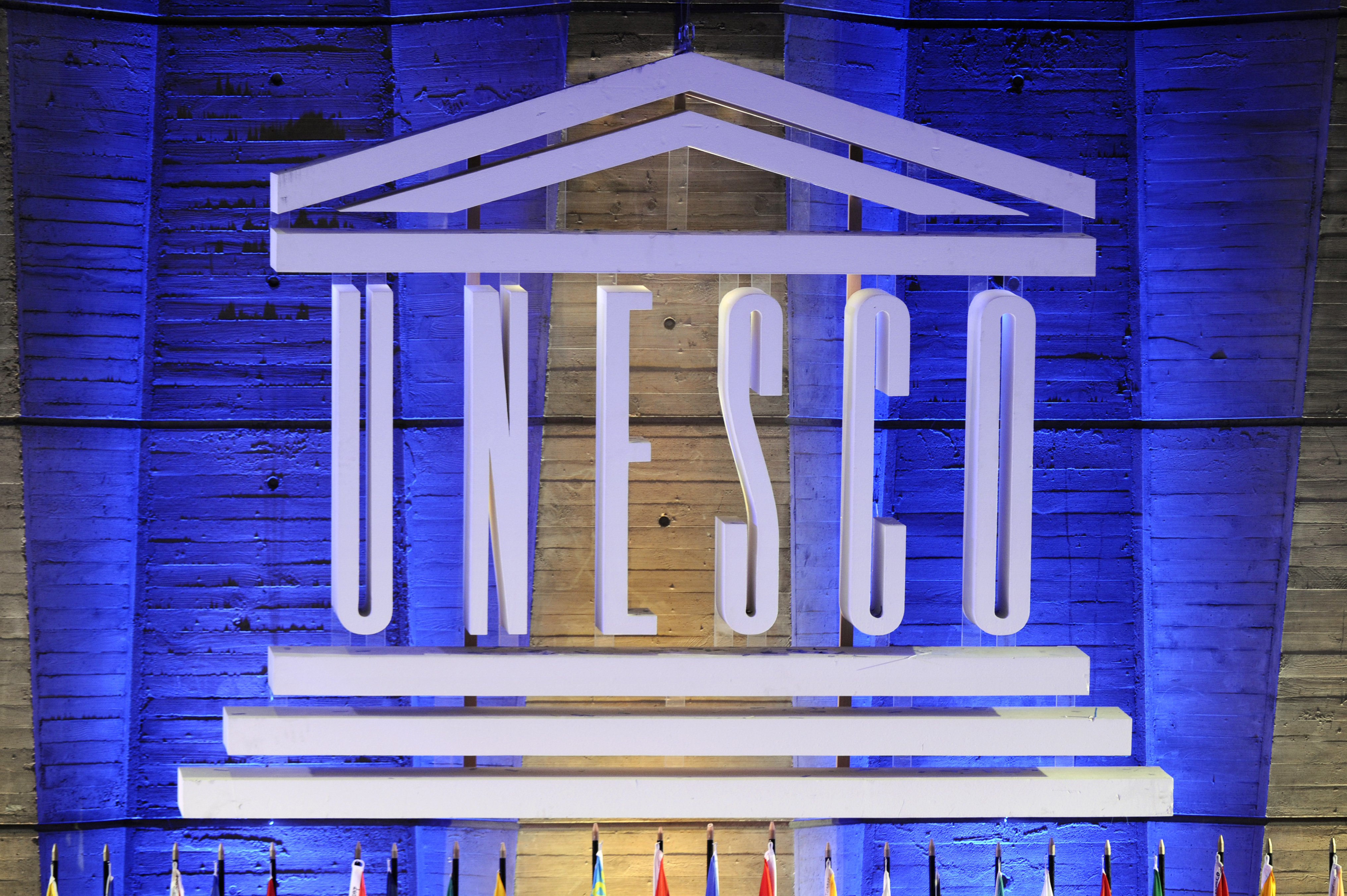 A logo of the United Nations Educational, Scientific and Cultural Organization (UNESCO) is displayed in front of the organization headquarters on September 14, 2011.
