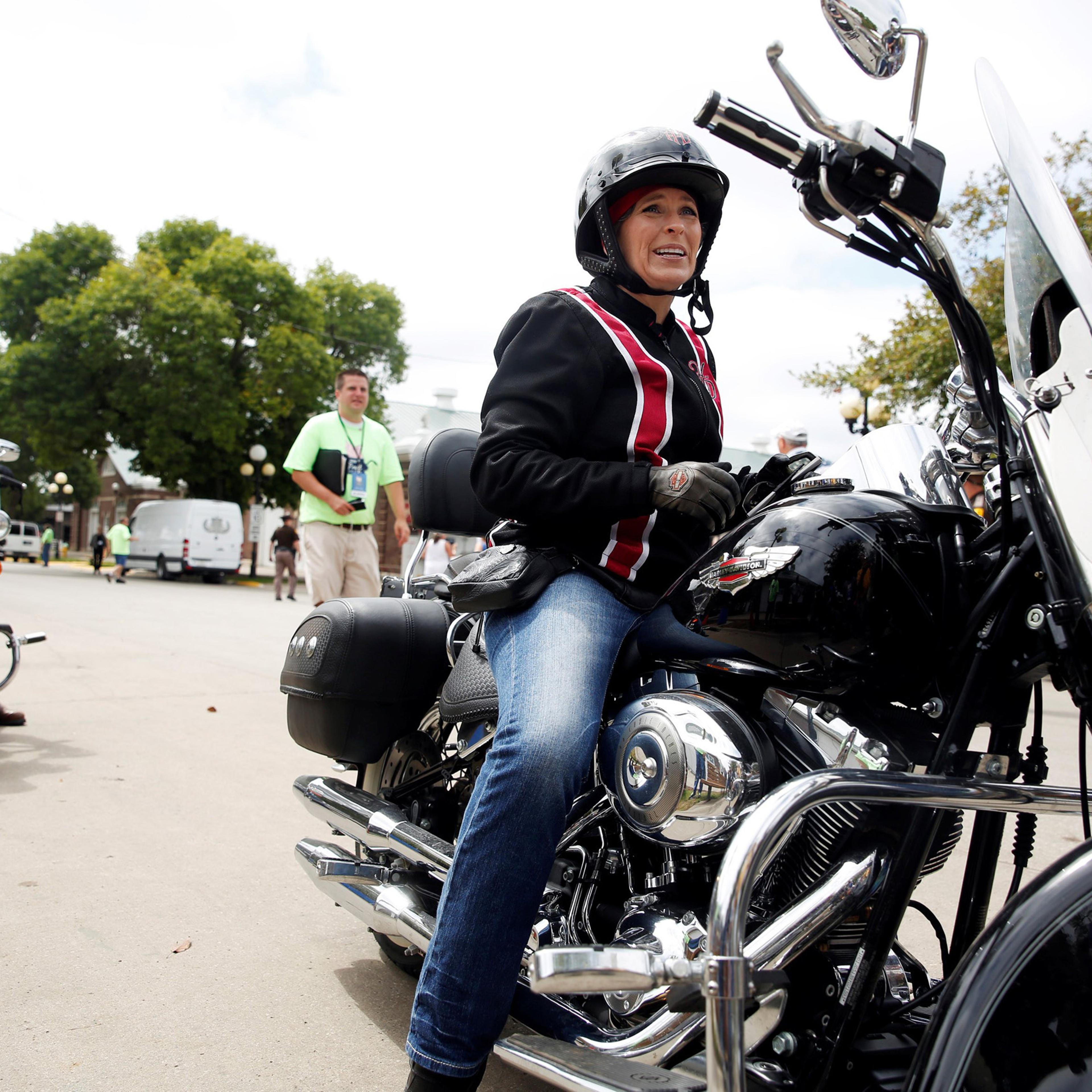 Iowa Senator Joni Ernst arrives via motorcycle to her annual Roast and Ride at the Iowa State Fairgrounds in Des Moines Aug. 27, 2016.
