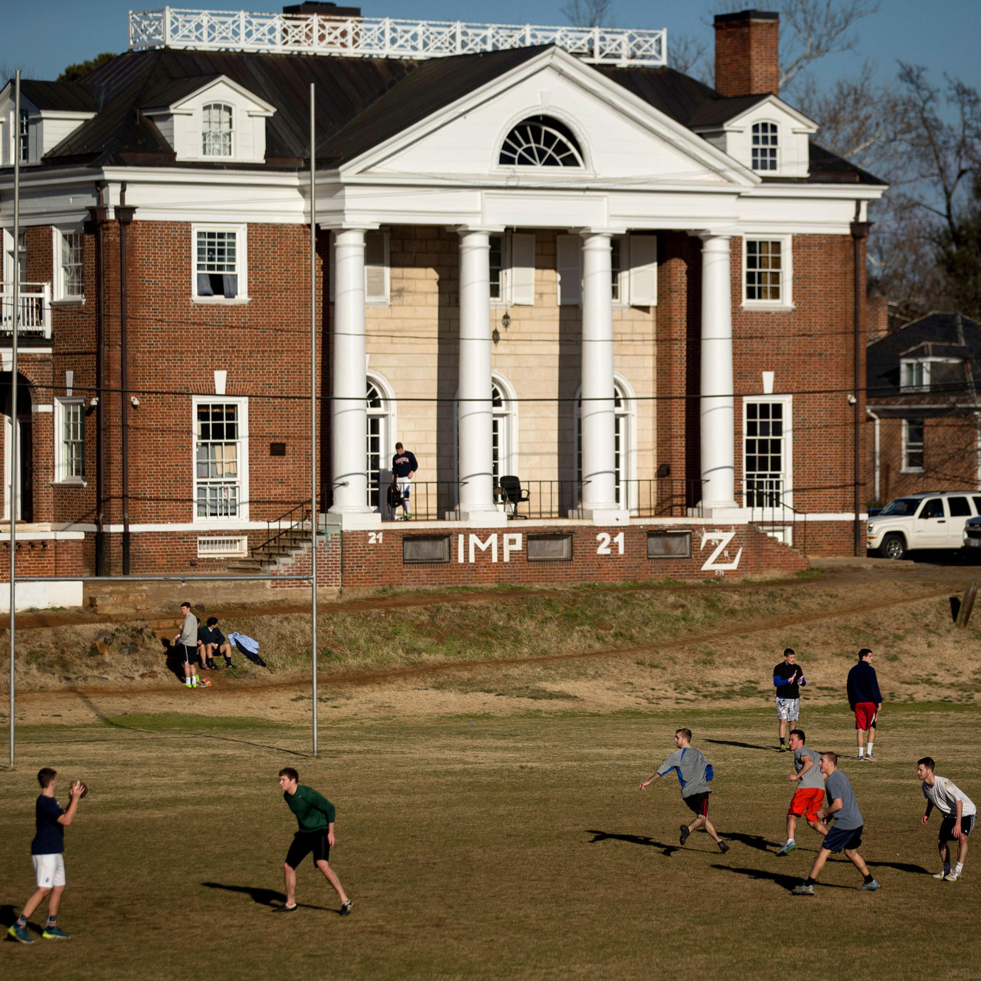 Students play football on the Madison Bowl field of the University of Virginia (UVA) campus next to the Phi Kappa Psi fraternity in Charlottesville, Va., on Jan. 16, 2015.