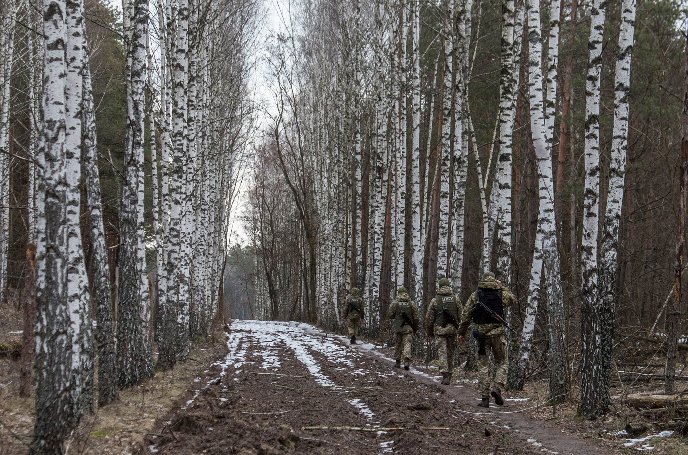 Ukrainian border guard officers patrol the Ukrainian-Belarusian state border at a checkpoint in Novi Yarylovychi, Ukraine, on Feb. 21