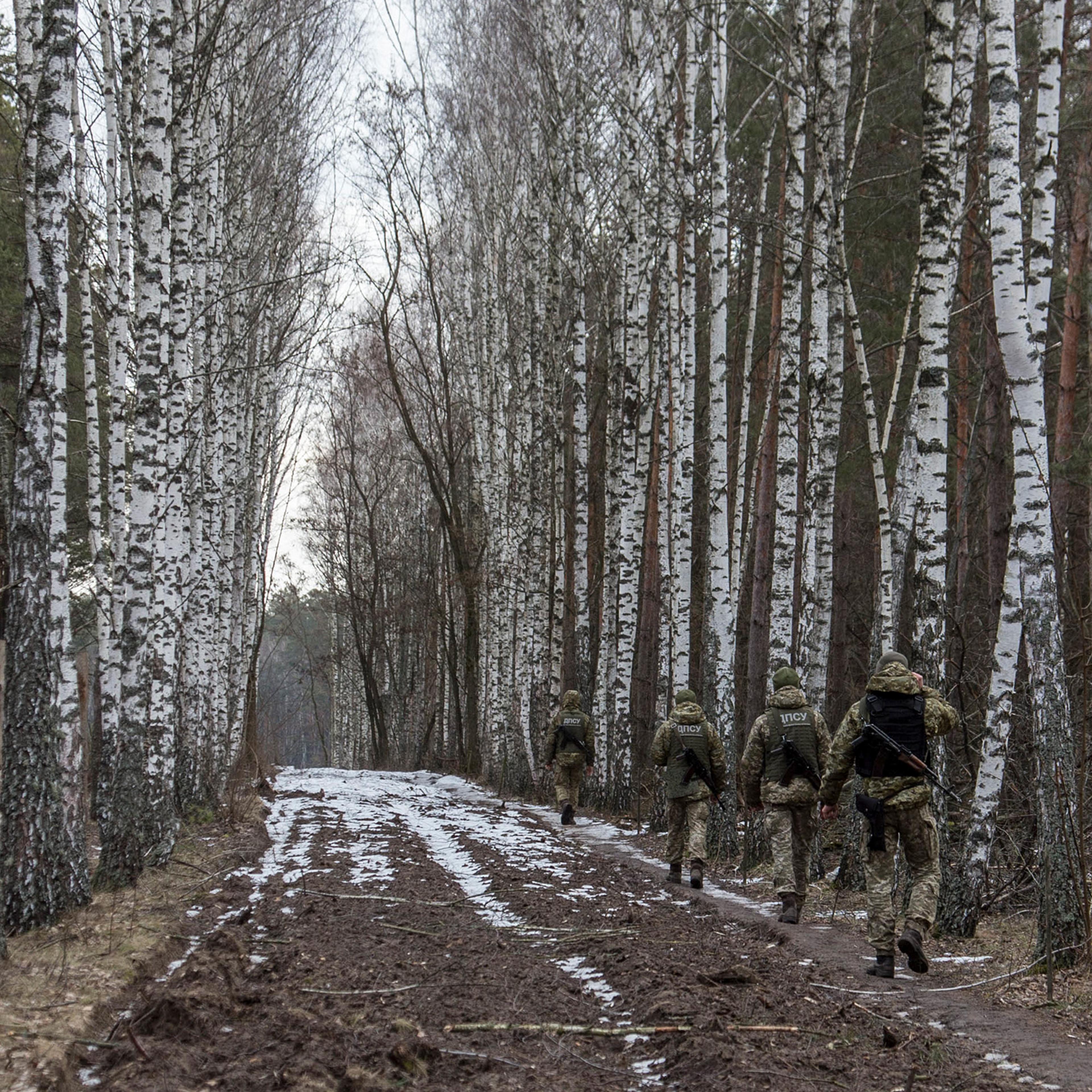 Ukrainian border guard officers patrol the Ukrainian-Belarusian state border at a checkpoint in Novi Yarylovychi, Ukraine, on Feb. 21