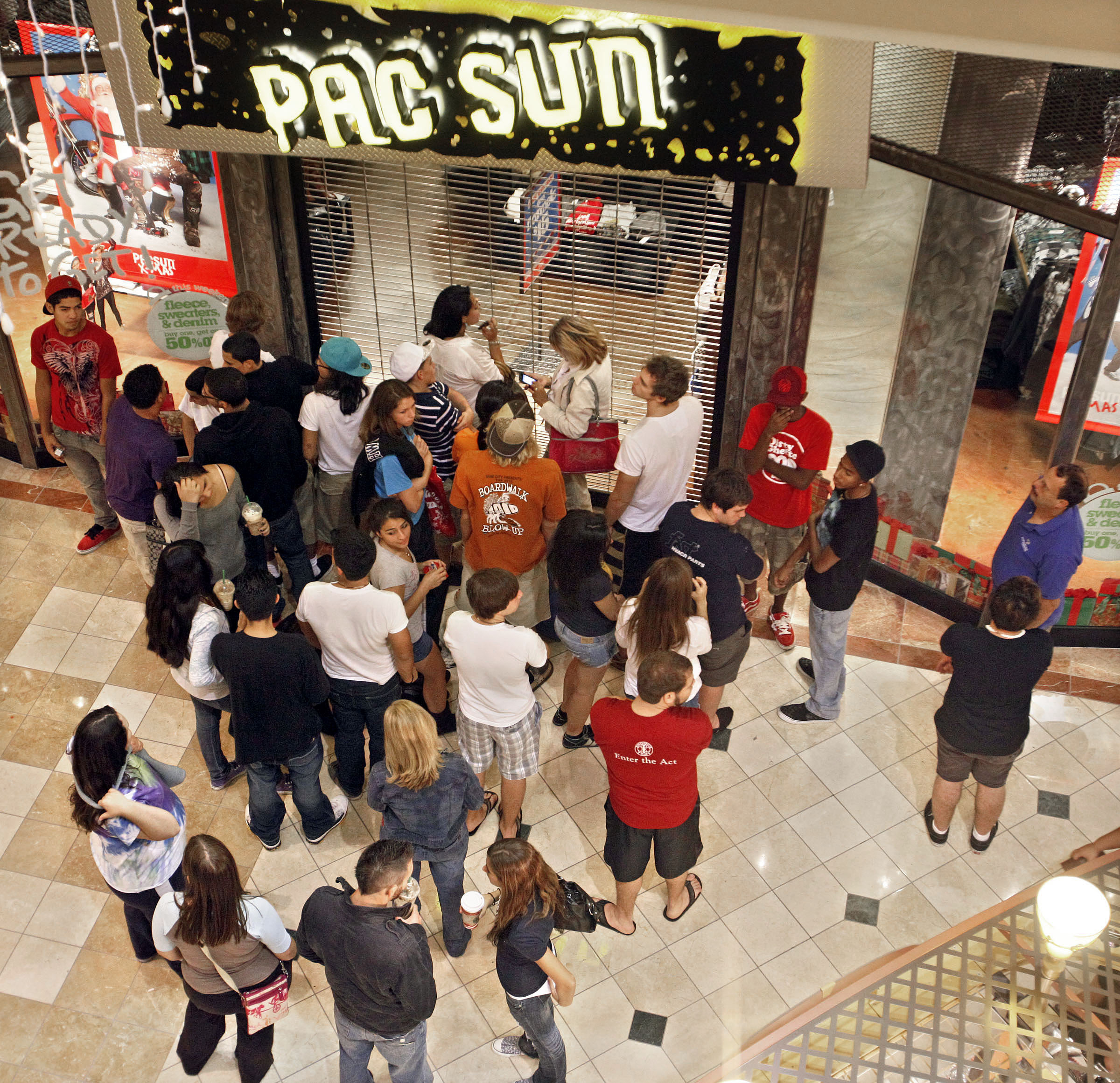 Black Friday shoppers wait outside the Pac Sun store in the Mall at Wellington Green before opening Nov. 26, 2010, Wellington, Fla.
