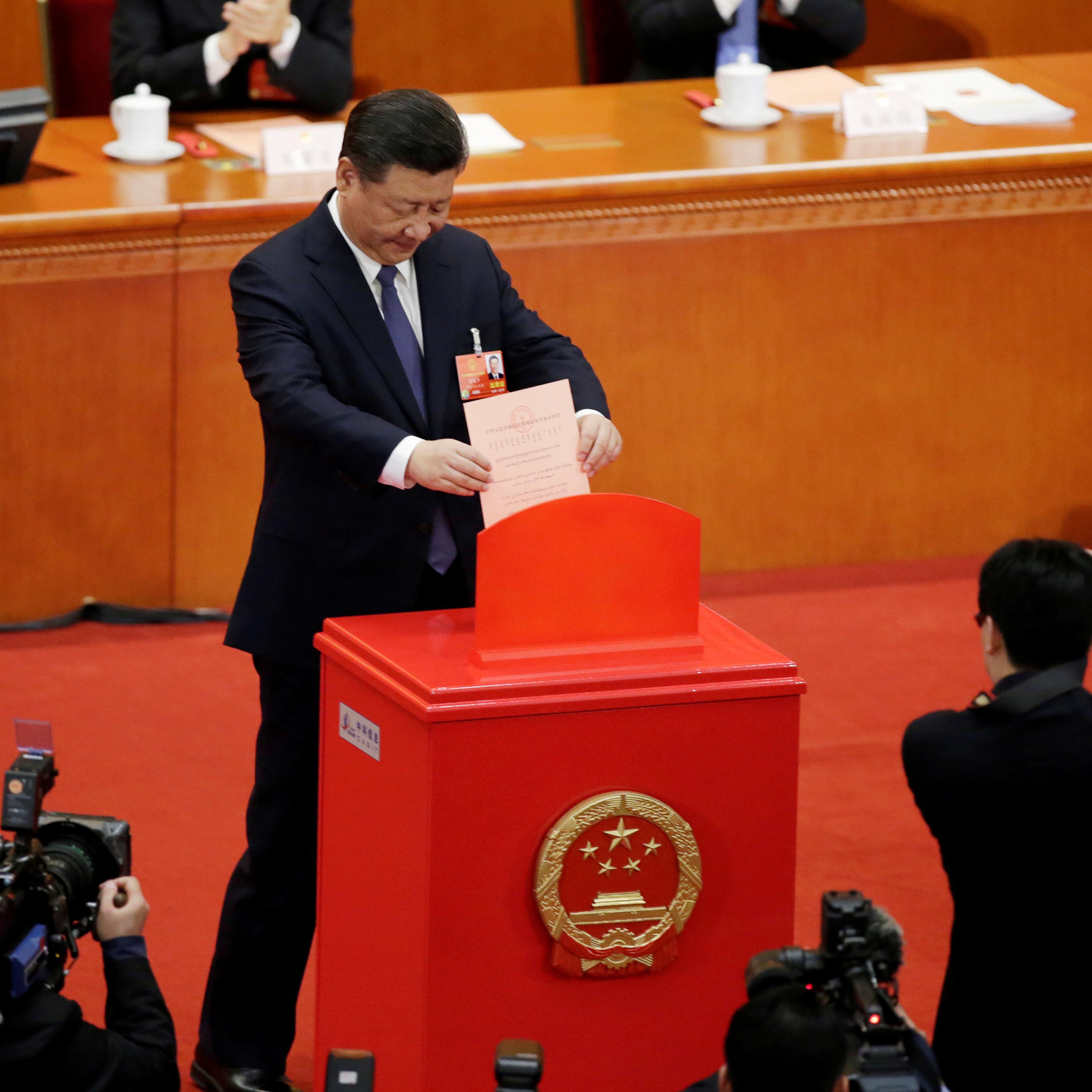 Chinese President Xi Jinping drops his ballot at the third plenary session of the National People's Congress (NPC) at the Great Hall of the People in Beijing