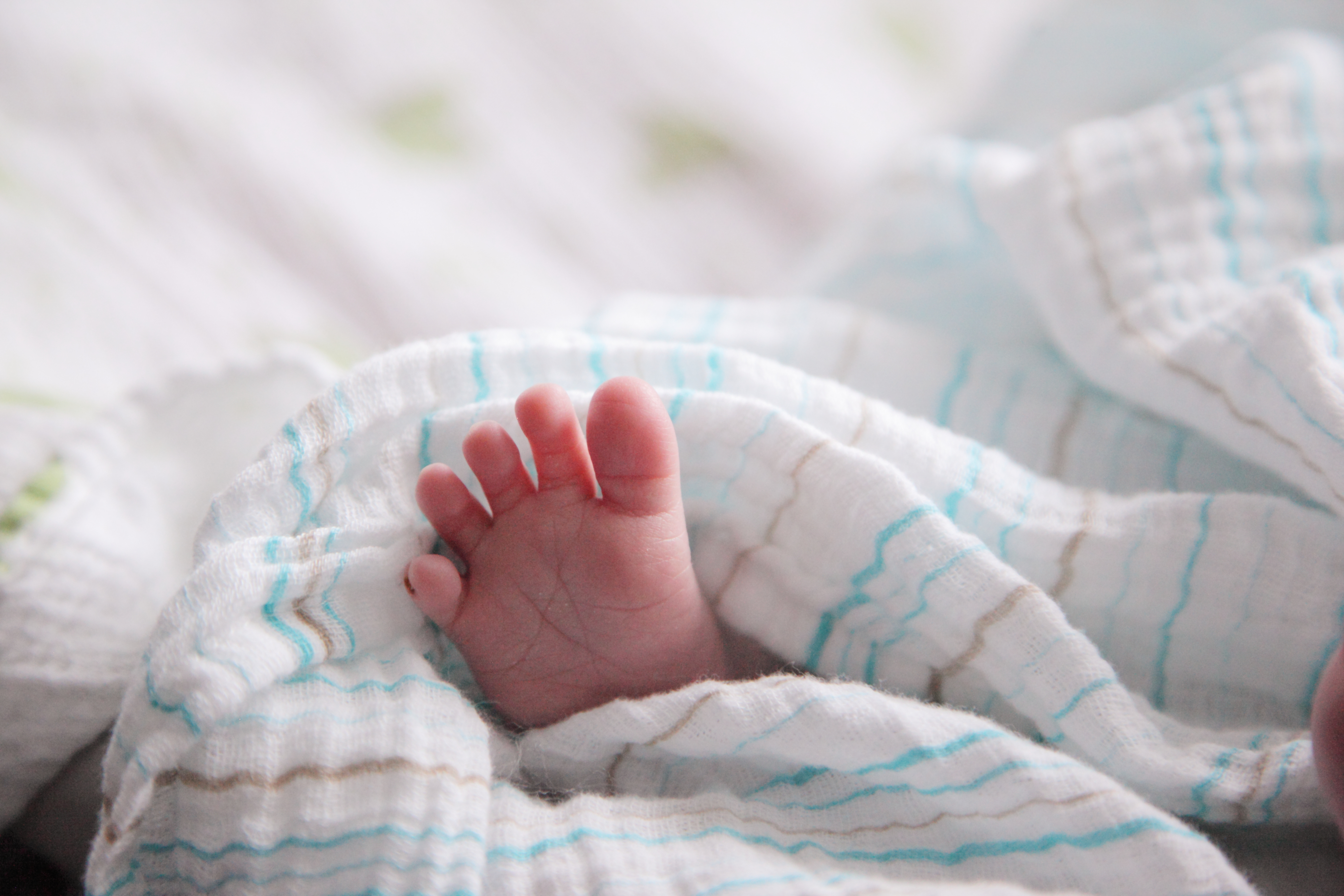Foot Of Baby Sleeping In Bed