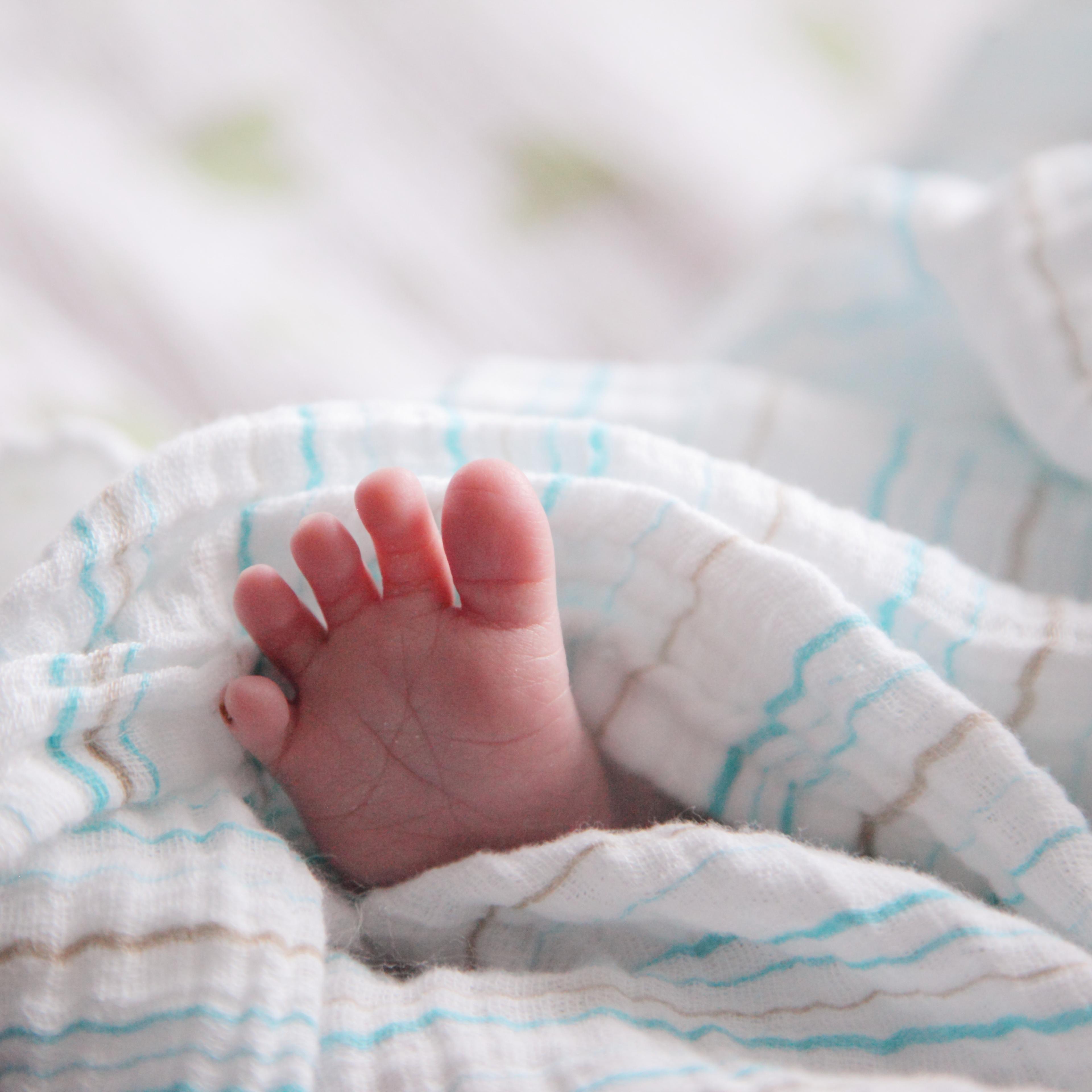 Foot Of Baby Sleeping In Bed