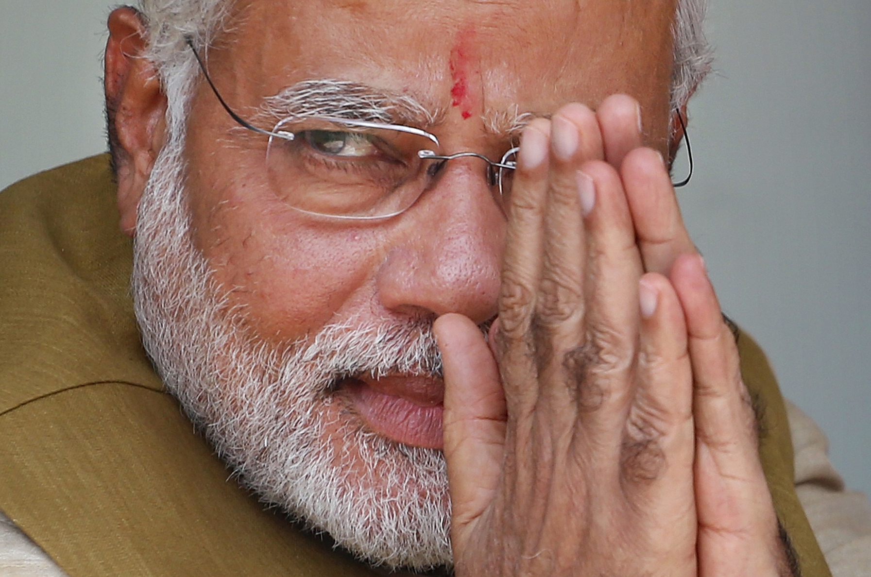 Opposition Bharatiya Janata Party (BJP) leader and India's next prime minister Narendra Modi greets the gathering at the home of his 90-year-old mother in Gandhinagar, in the western Indian state of Gujarat, on May 16, 2014.