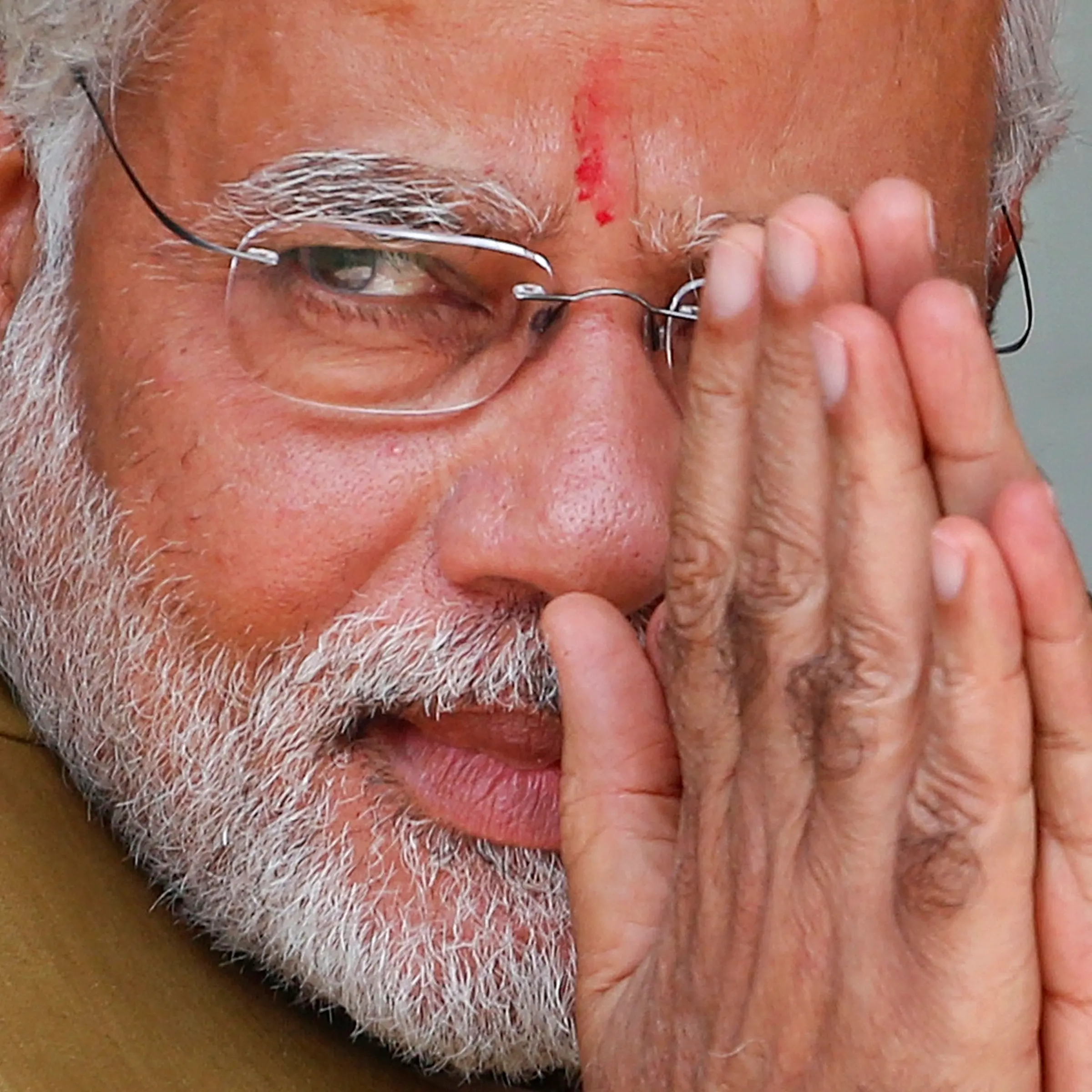 Opposition Bharatiya Janata Party (BJP) leader and India's next prime minister Narendra Modi greets the gathering at the home of his 90-year-old mother in Gandhinagar, in the western Indian state of Gujarat, on May 16, 2014.