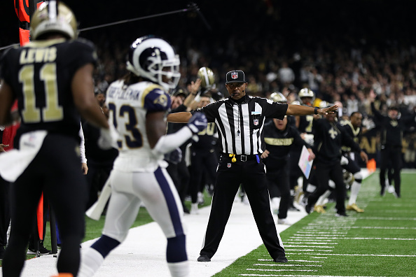 A referee watches as Tommylee Lewis #11 of the New Orleans Saints drops a pass broken up by Nickell Robey-Coleman #23 of the Los Angeles Rams during the fourth quarter in the NFC Championship game at the Mercedes-Benz Superdome on January 20, 2019 in New