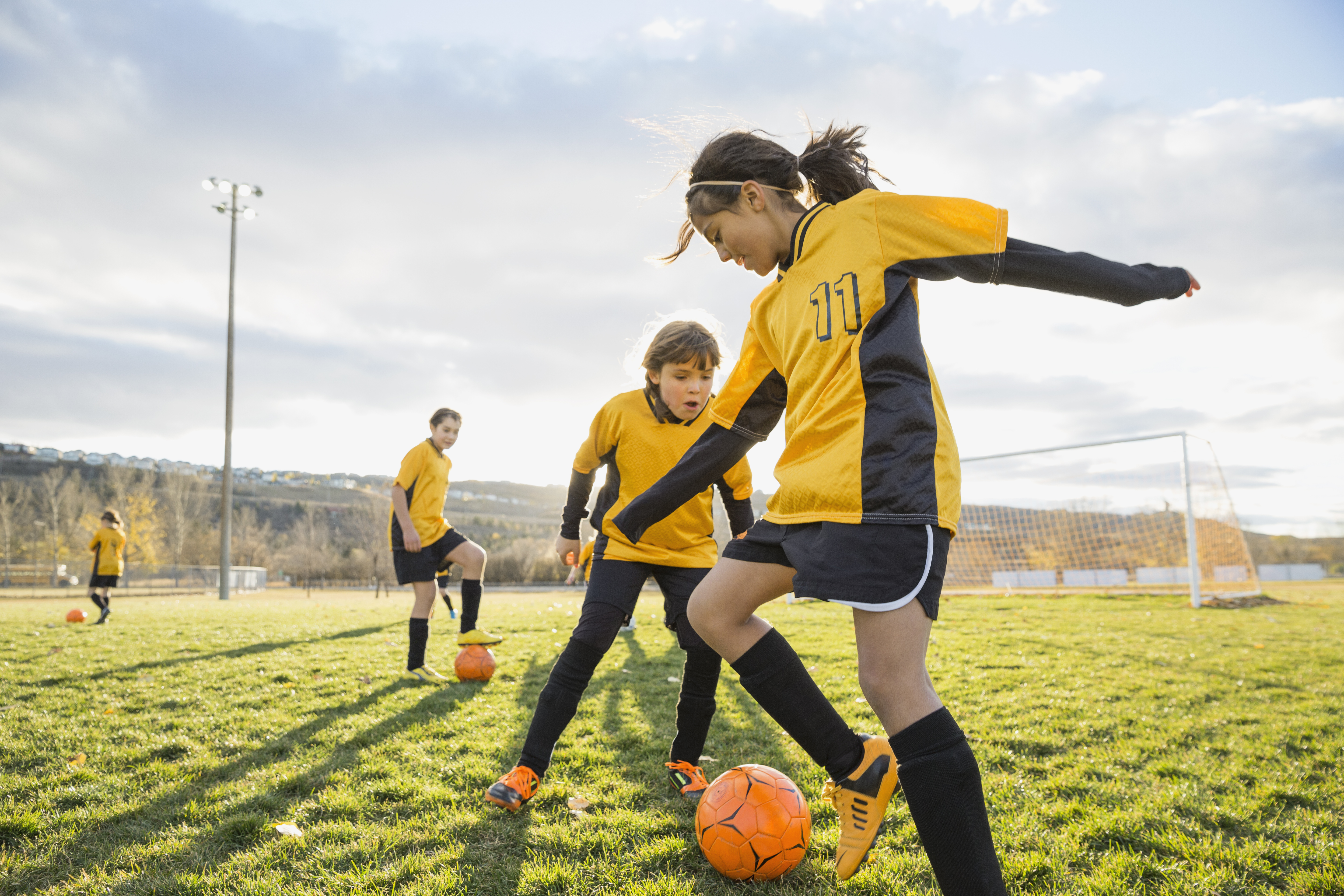 girl-playing-soccer-field