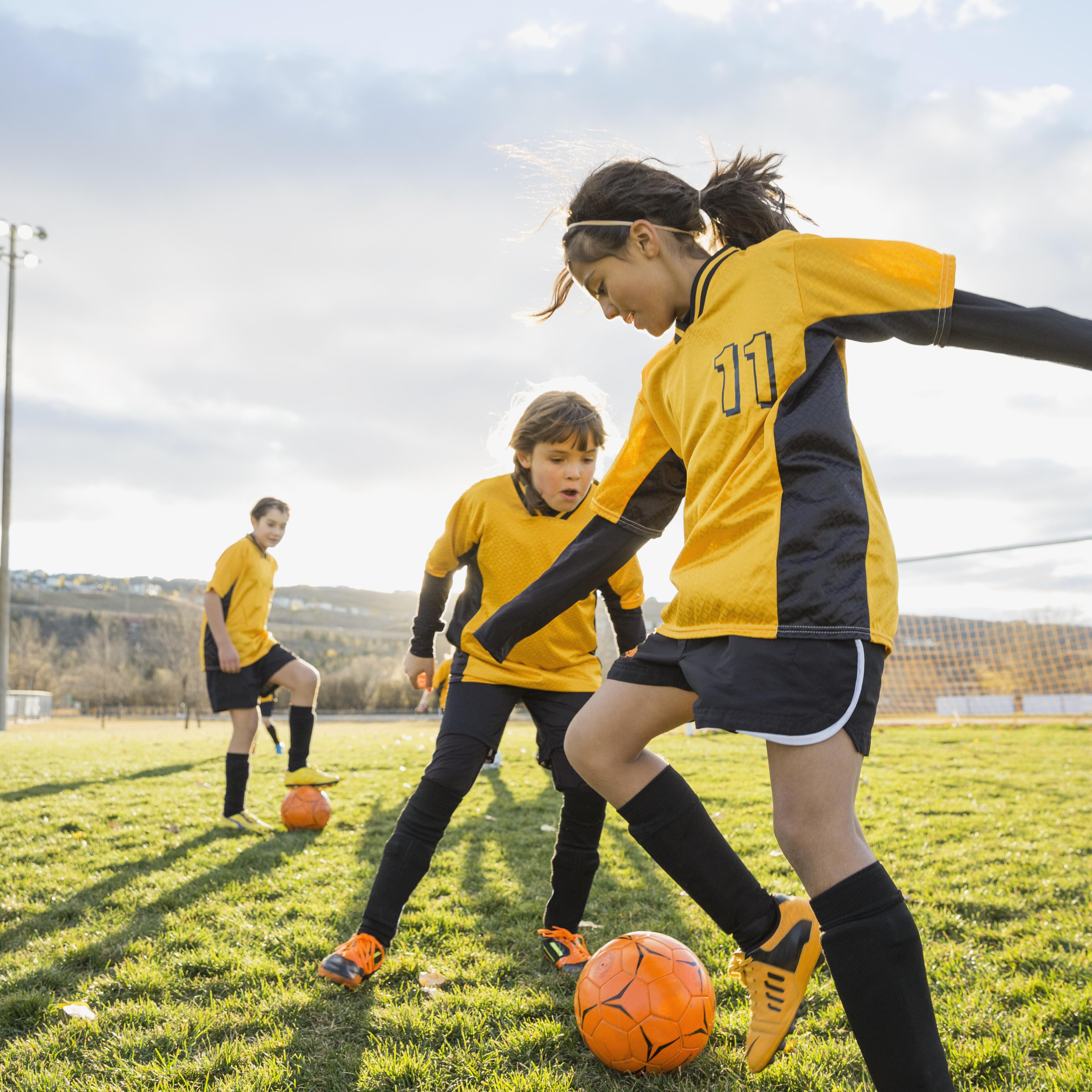 girl-playing-soccer-field