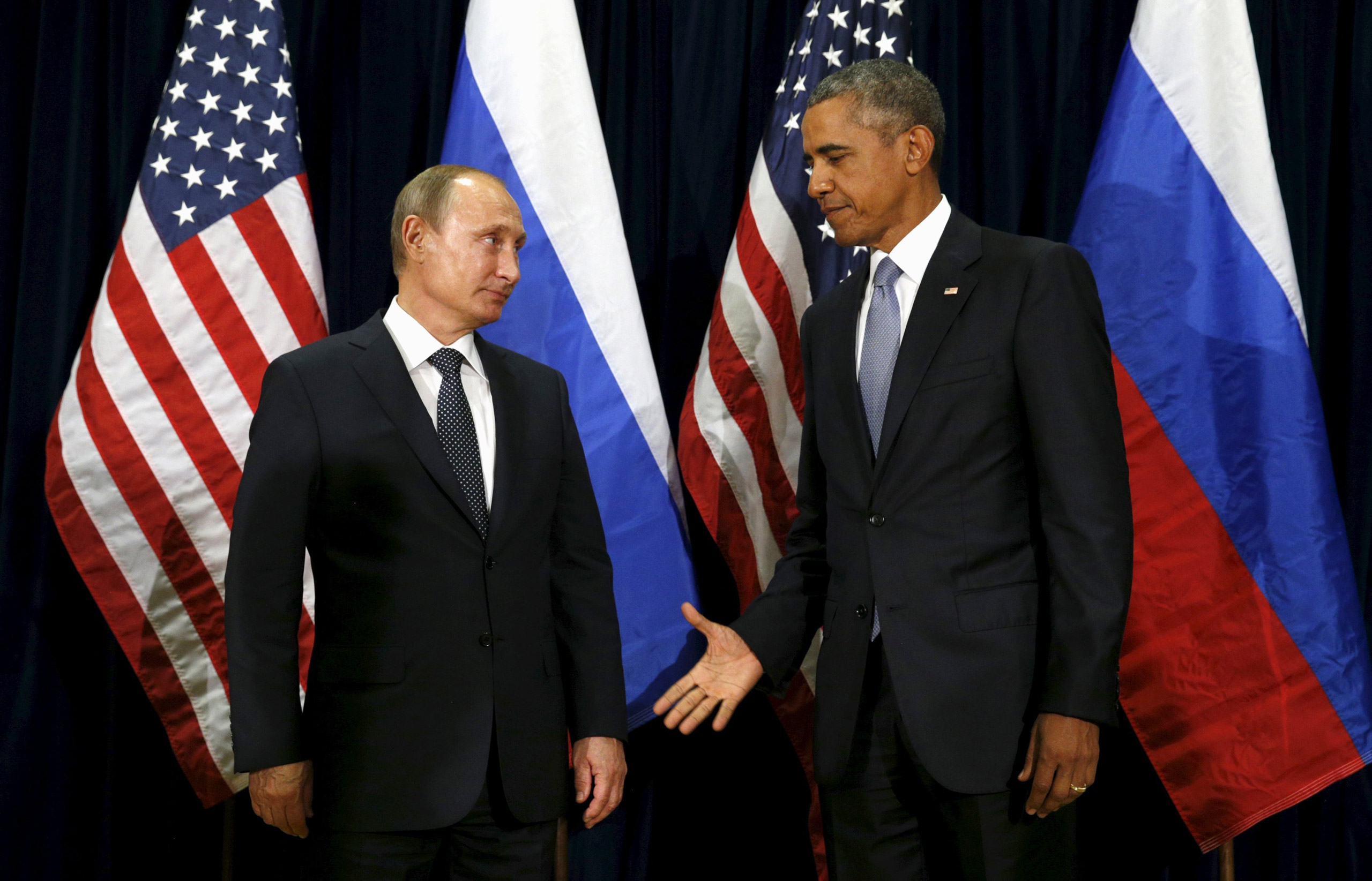 U.S. President Barack Obama extends his hand to Russian President Vladimir Putin during their meeting at the United Nations General Assembly in New York
