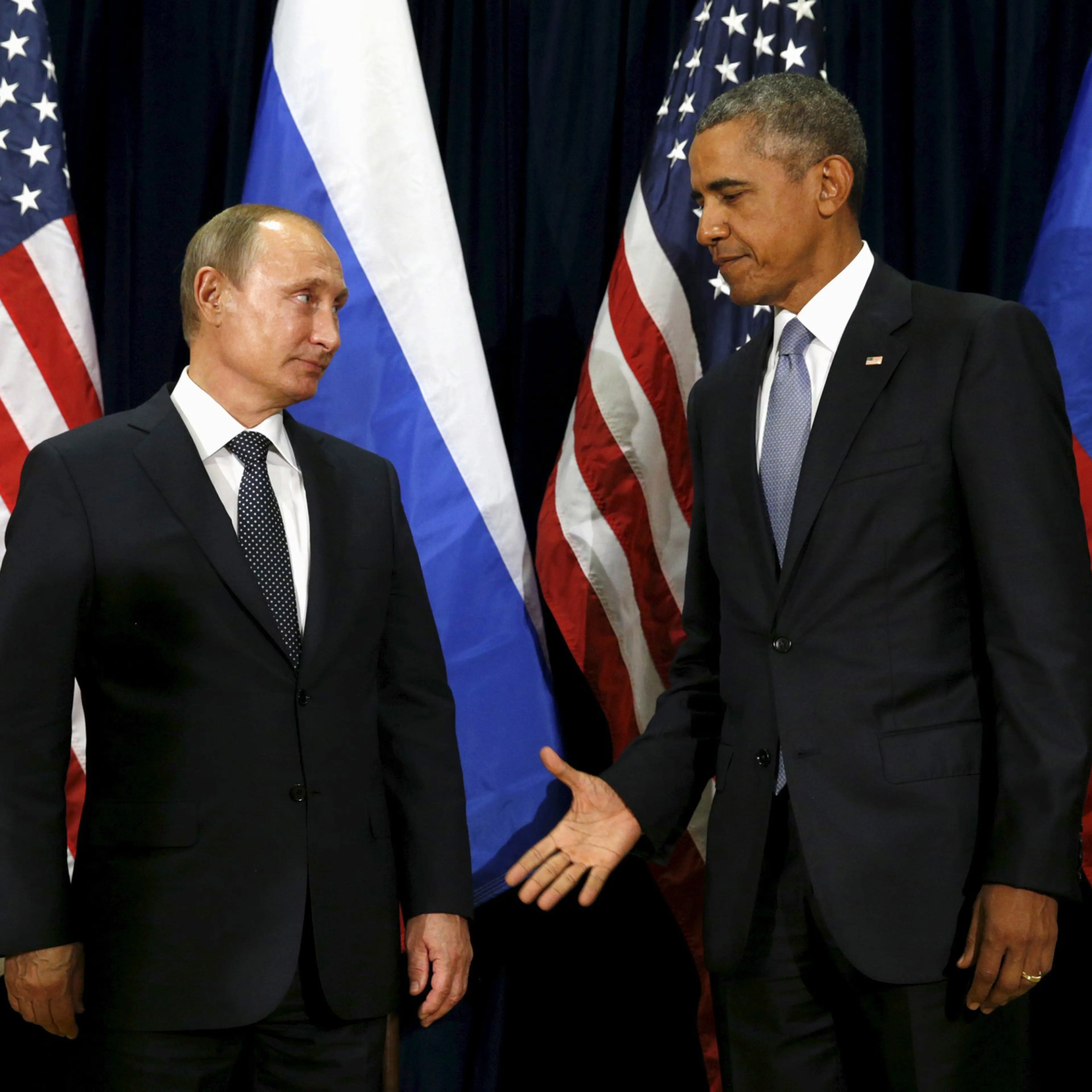 U.S. President Barack Obama extends his hand to Russian President Vladimir Putin during their meeting at the United Nations General Assembly in New York