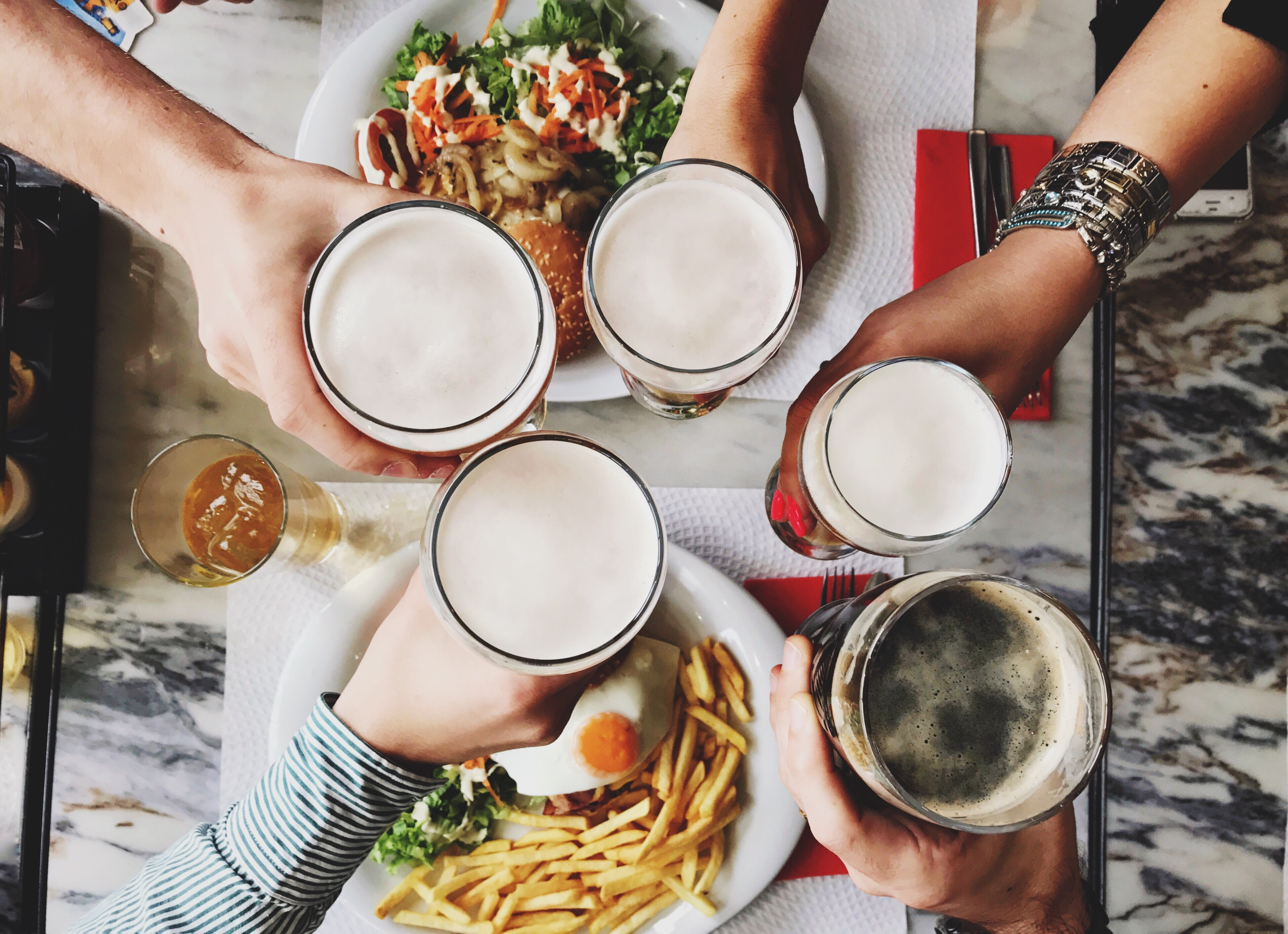 Friends toasting over fries