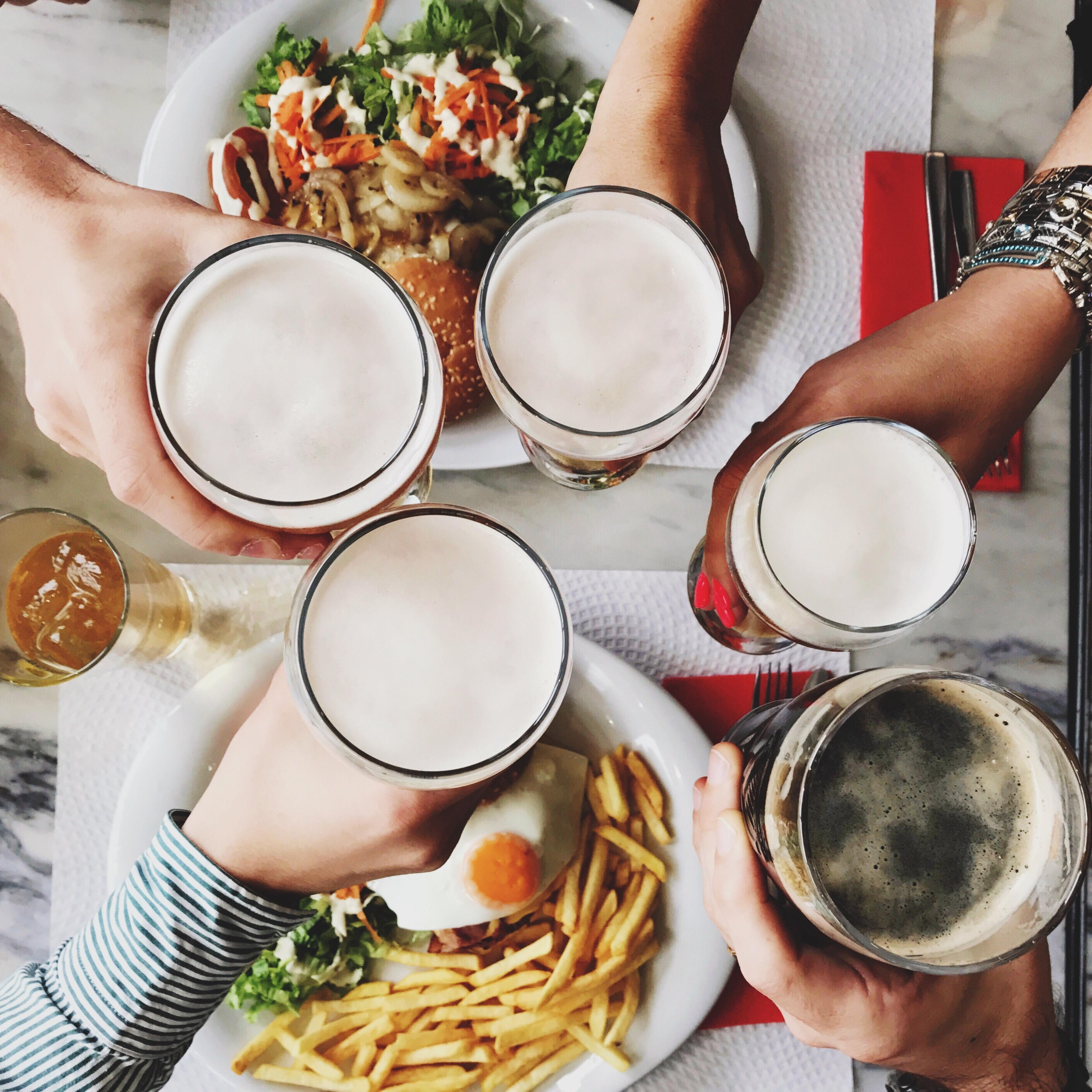 Friends toasting over fries